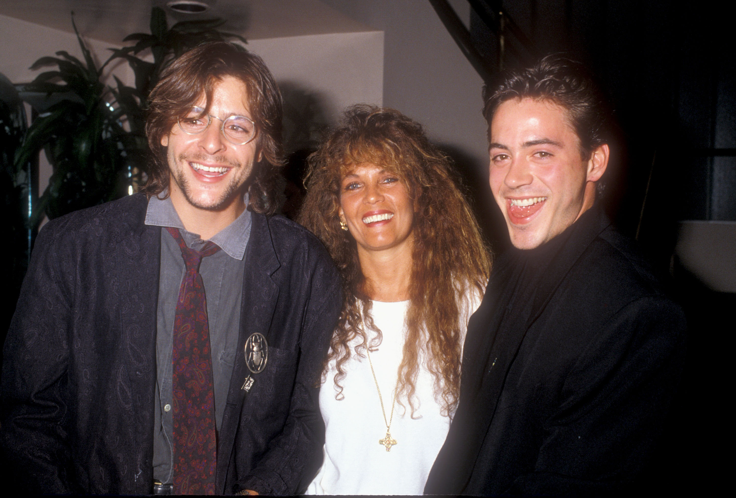 Flashing a broad smile alongside jewelry designer Loree Rodkin and a playful Robert Downey, Jr., the actor attended an Amnesty International benefit event in 1988. | Source: Getty Images