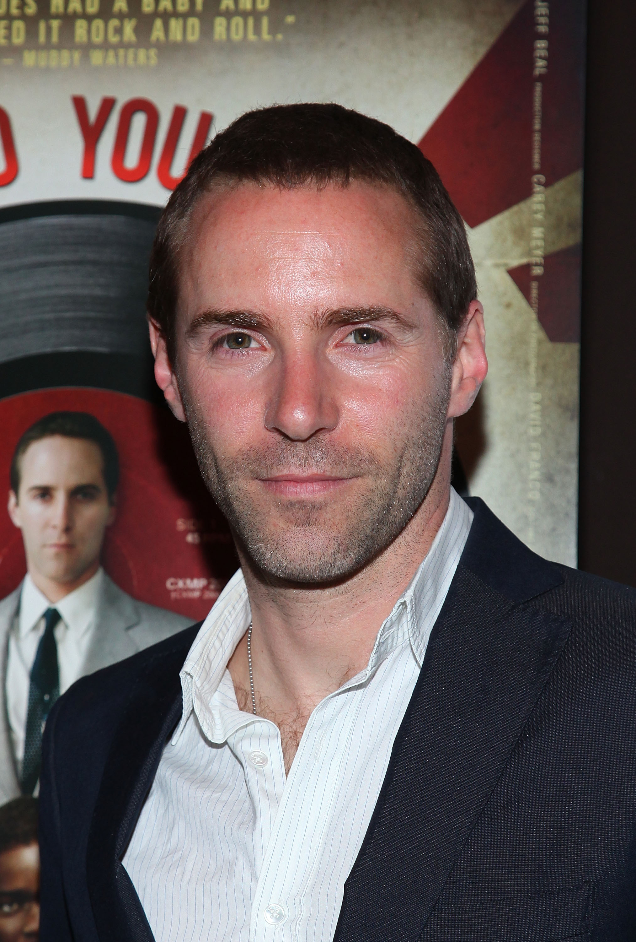 Alessandro Nivola attended the premiere of "Who Do You Love" in 2010 in New York wearing a classic dark blazer over an open-collared striped shirt. With his short-cropped hair and understated style, he projected quiet confidence and emerging-star charm.