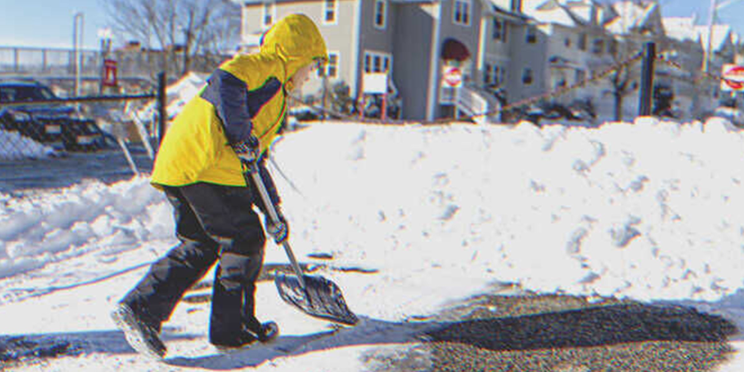 A boy shoveling snow | Source: Shutterstock
