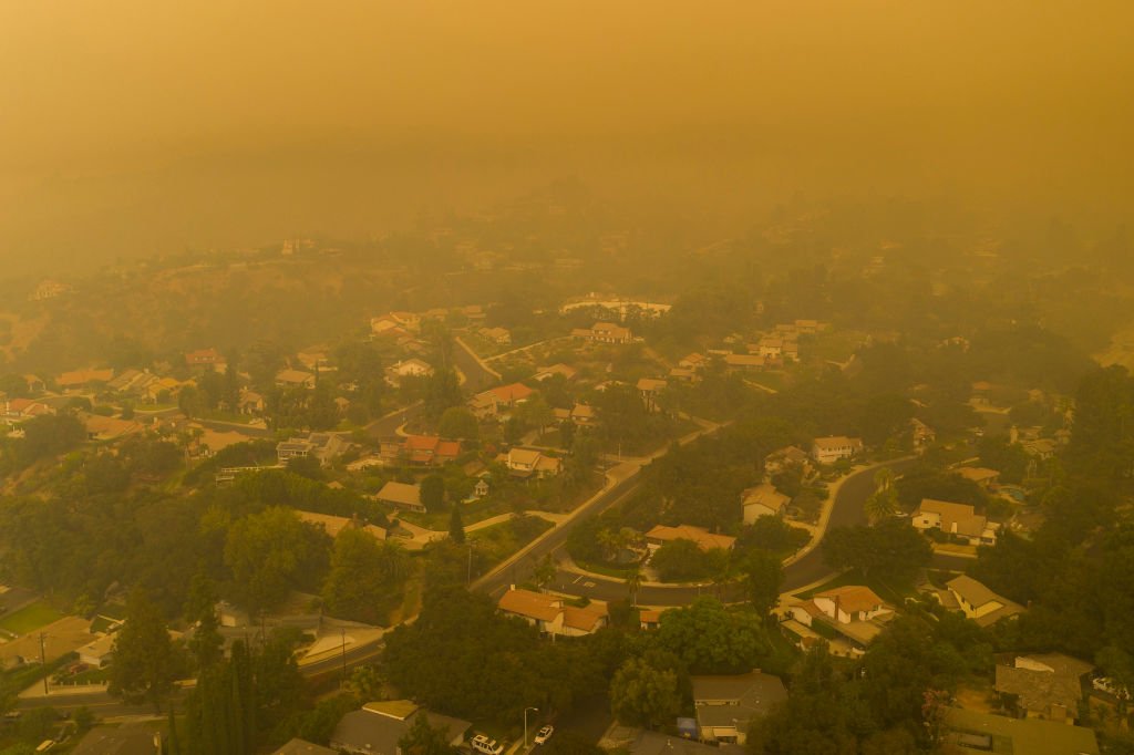An aerial view shows neighborhoods enshrouded in smoke as the Bobcat Fire burns East of Los Angeles. September 13, 2020 | Source: Getty Images