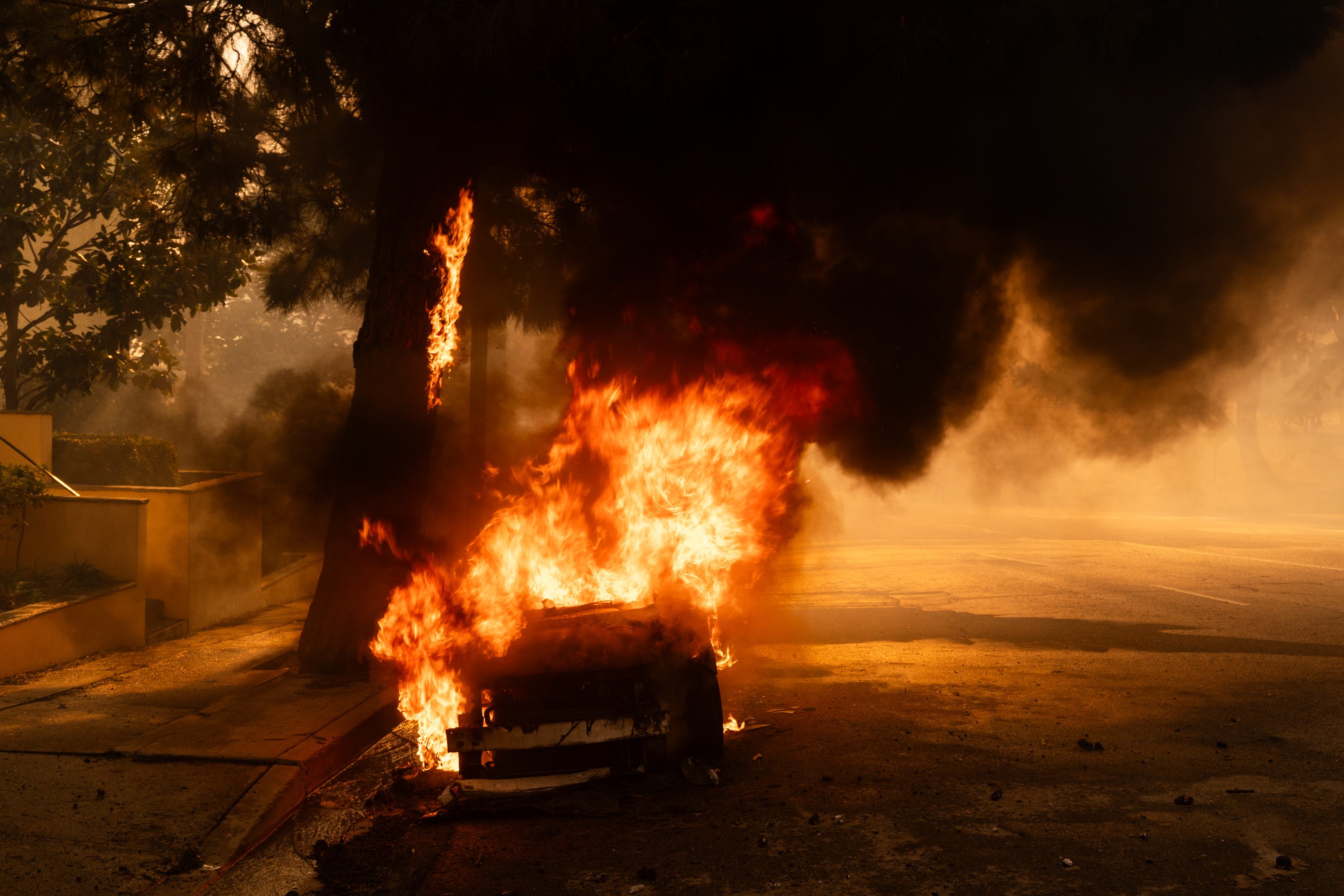 Smoke rises from a burning vehicle as the brush fire spreads in Pacific Palisades, Los Angeles, California on January 7, 2025 | Source: Getty Images