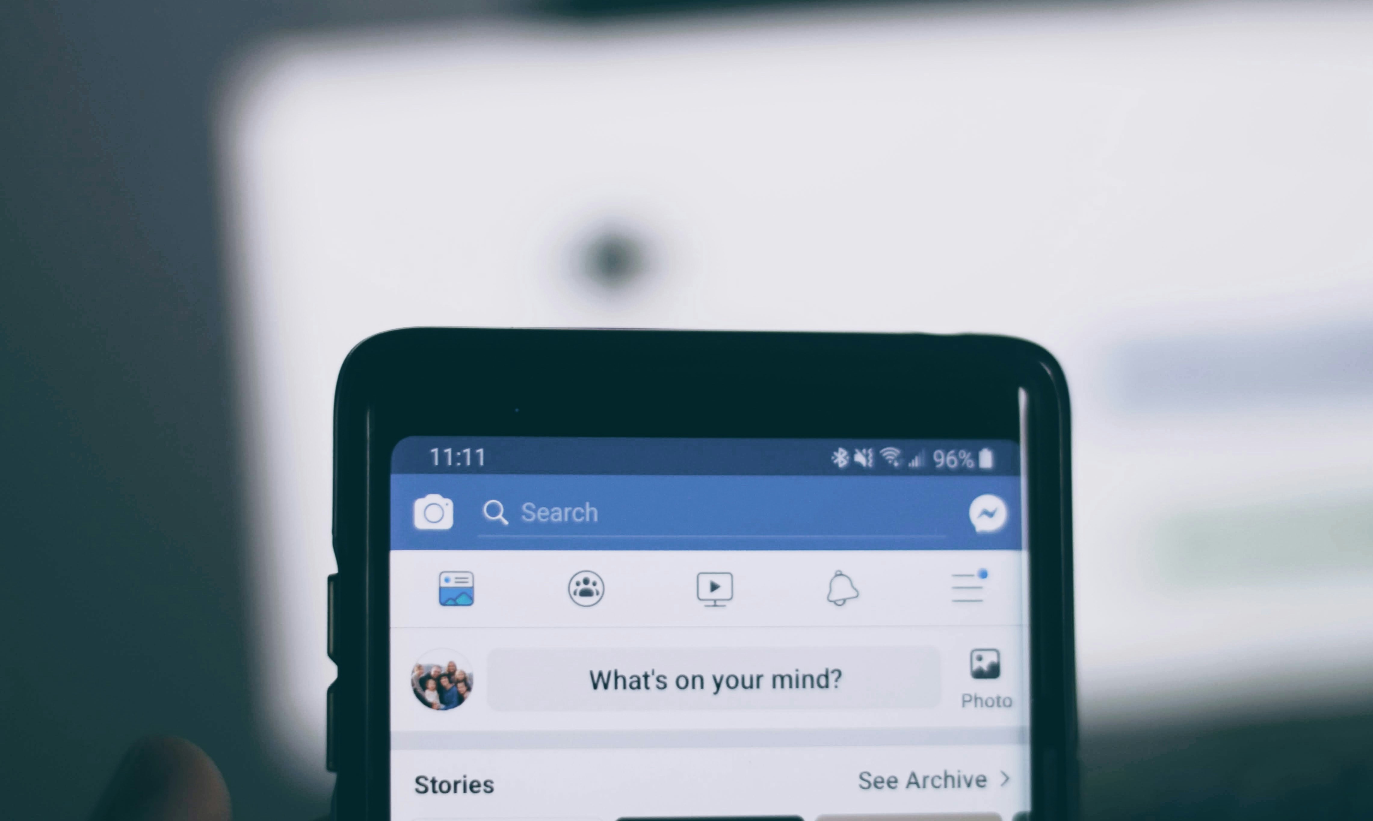 A phone showing Facebook home screen | Source: Unsplash