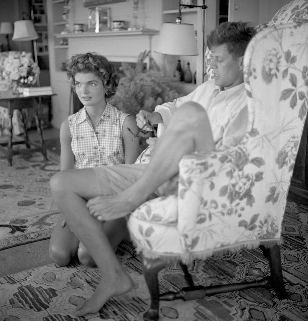 Senator John F. Kennedy and fiance Jacqueline Bouvier interviewed for a LIFE Magazine story while on vacation at the Kennedy compound in June 1953, in Hyannis Port, Massachusetts. | Source: Hy Peskin/Getty Images