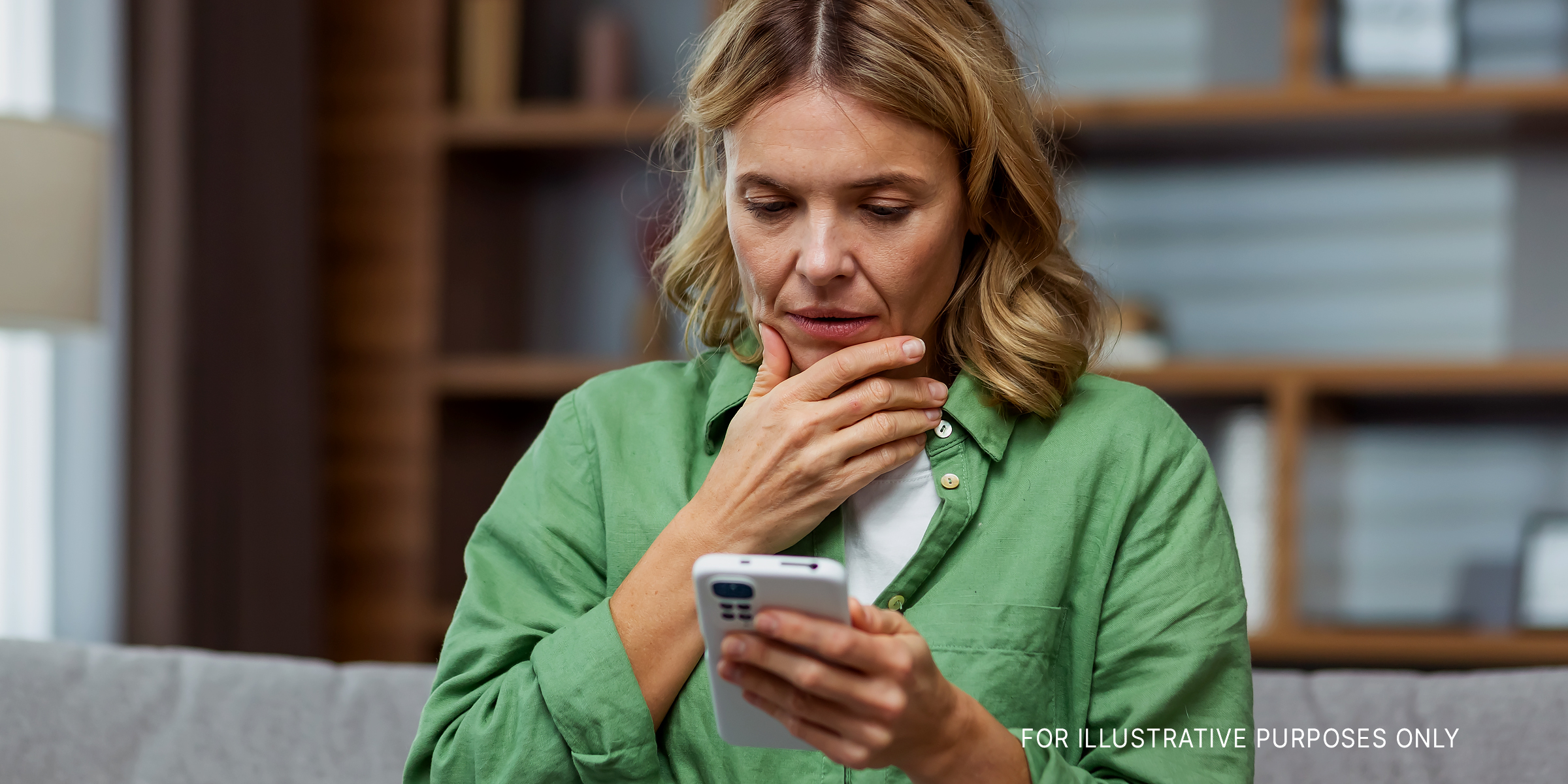 Woman looking at her phone, perplexed | Source: Shutterstock