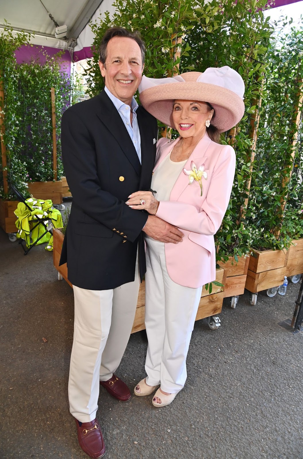 On May 20, 2024, Joan Collins and Percy Gibson attended the RHS Chelsea Flower Show at the Killik & Co "Money Doesn't Grow On Trees" Garden, showcasing their enduring partnership amid vibrant surroundings. | Source: Getty Images