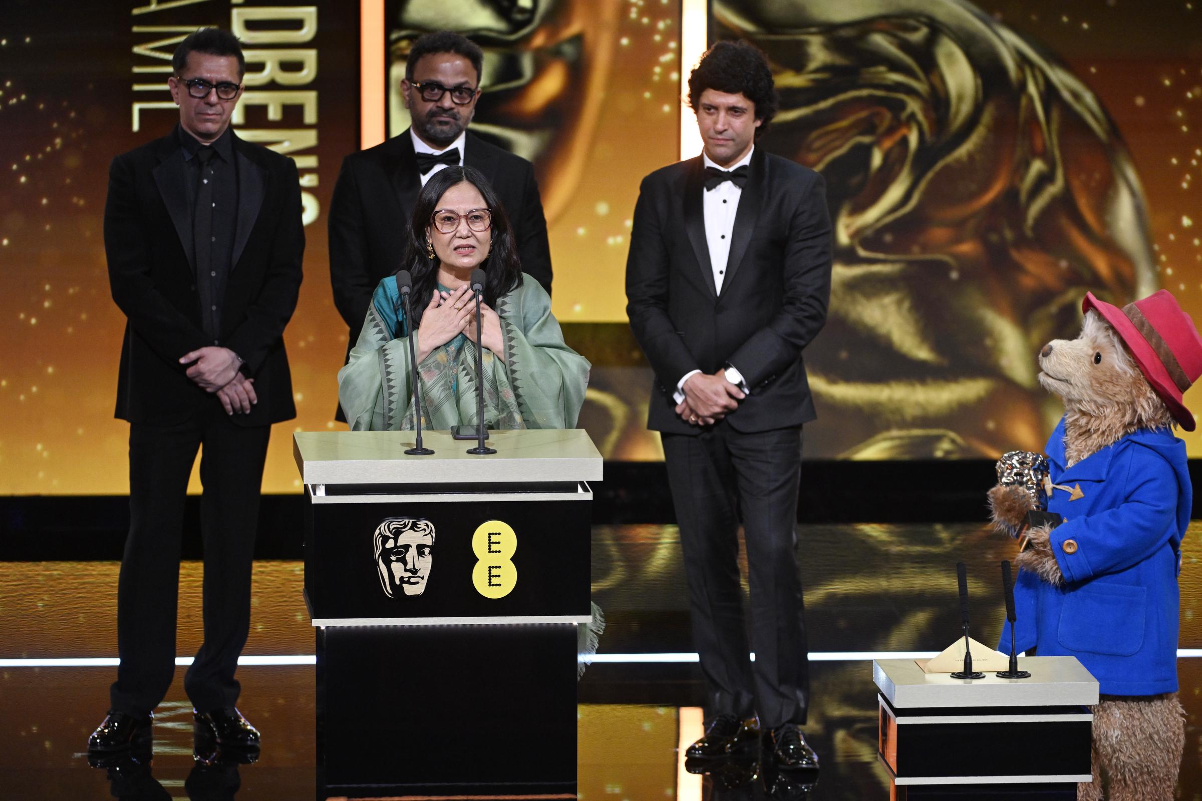 Ritesh Sidhwani, Alan McAlex, Farhan Akhtar, and Lakshmipriya Devi accept the Children's & Family Film Award for "Boong" during the EE BAFTA Awards on February 22, 2026, in London, England. | Source: Getty Images