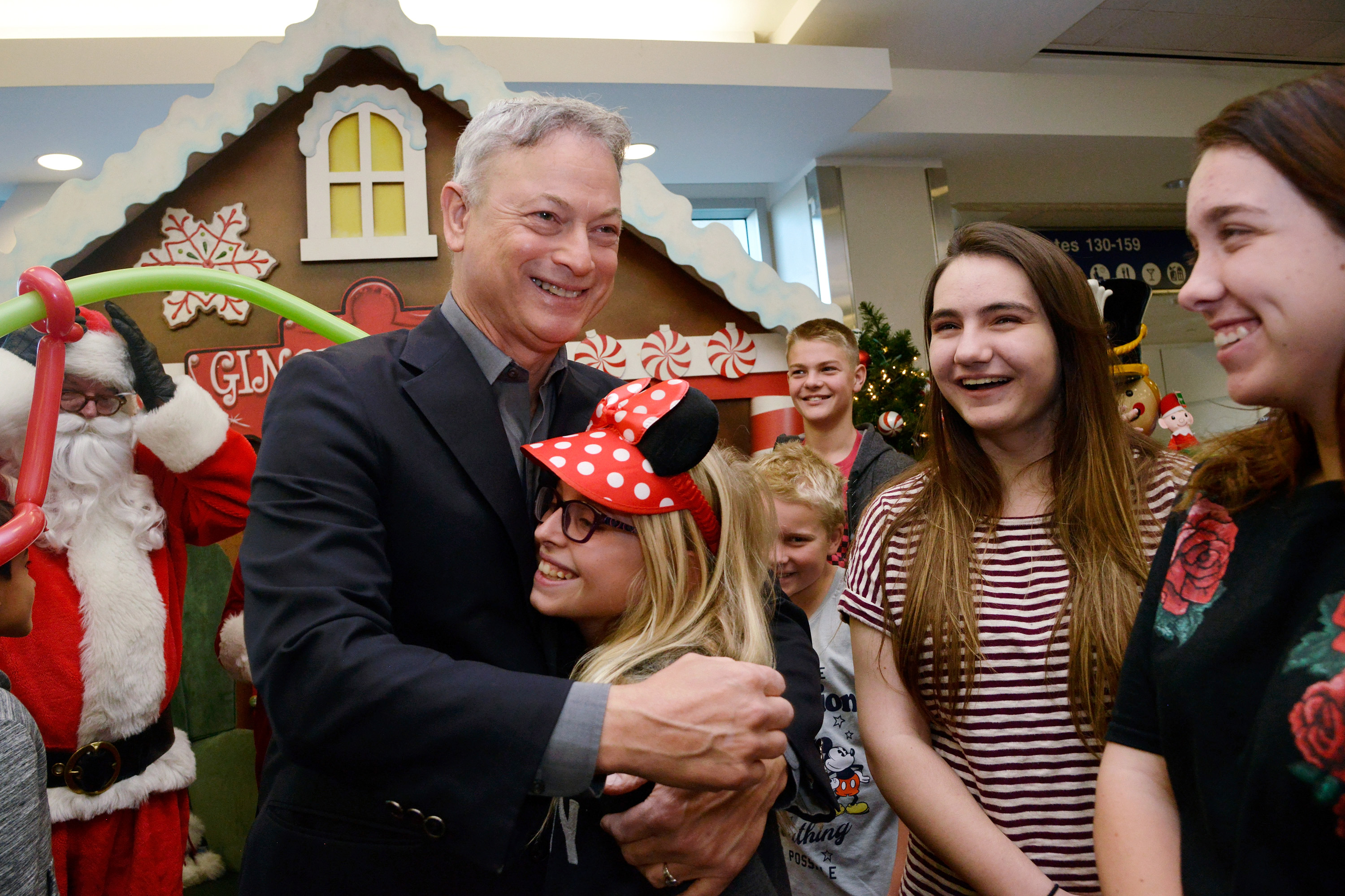 Gary Sinise meets with Gold Star families at the Gary Sinise Foundation's Snowball Express Send-Off Celebration at LAX Airport in Los Angeles, California, on December 8, 2018. | Source: Getty Images