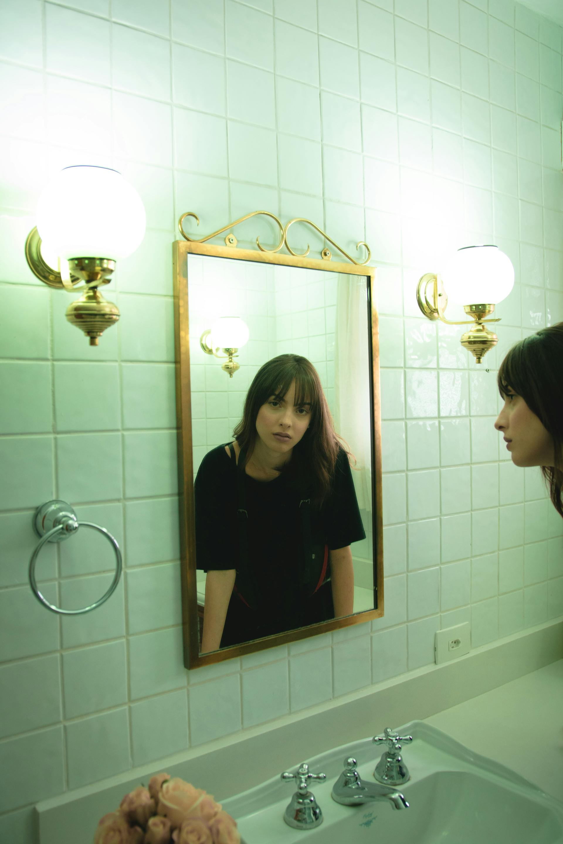 A woman staring into a mirror | Source: Pexels