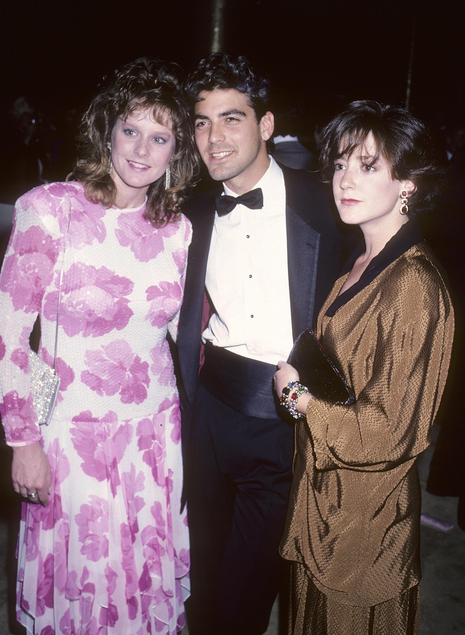 George Clooney and Talia Balsam attend the First Annual Singers' Salute to the Songwriter with a friend on April 7, 1986 | Source: Getty Images