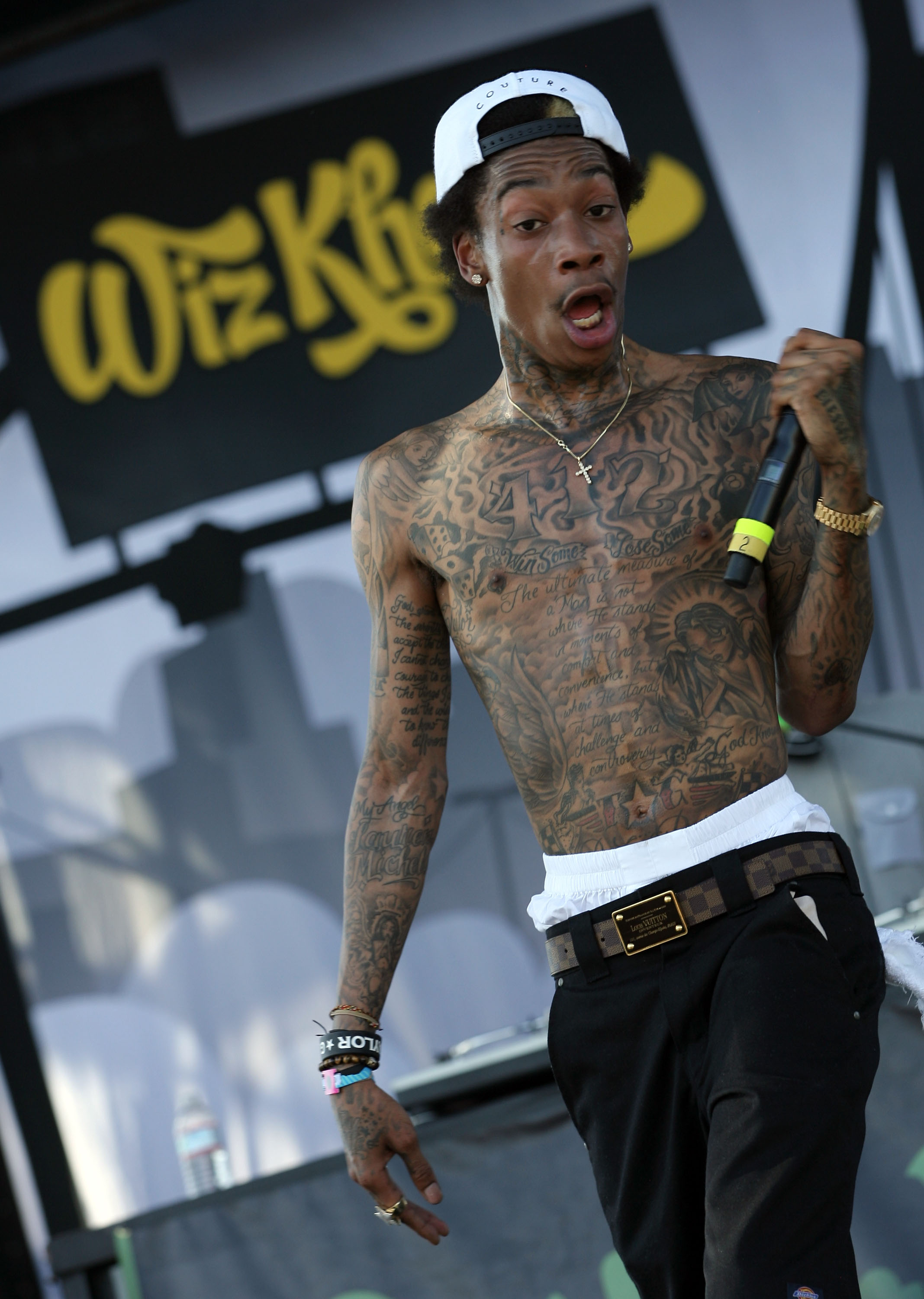 Wiz Khalifa shows off the wiry physique that defined his early years in the spotlight while performing during Day 3 of the Coachella Valley Music & Arts Festival at the Empire Polo Club in Indio, California, on April 17, 2011. Shirtless on stage, the rapper's lean frame stood in sharp contrast to the muscular build he would develop years later through MMA training.