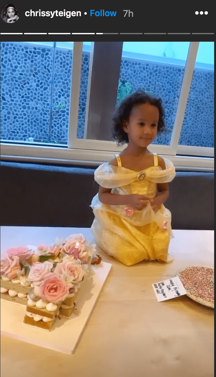 Chrissy Teigen shared a photo of her daughter Luna Stevenson sitting on a table in front of two birthday cakes for her fourth birthday | Source: Instagram.com/chrissyteigen