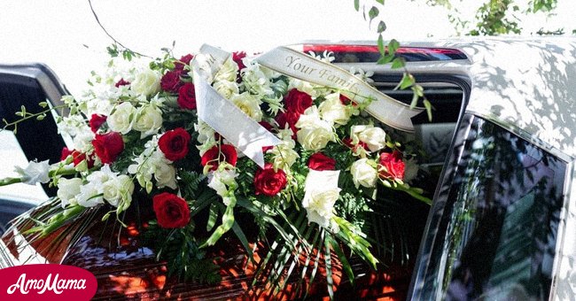 A hearse and coffin with flowers | Source: Shutterstock