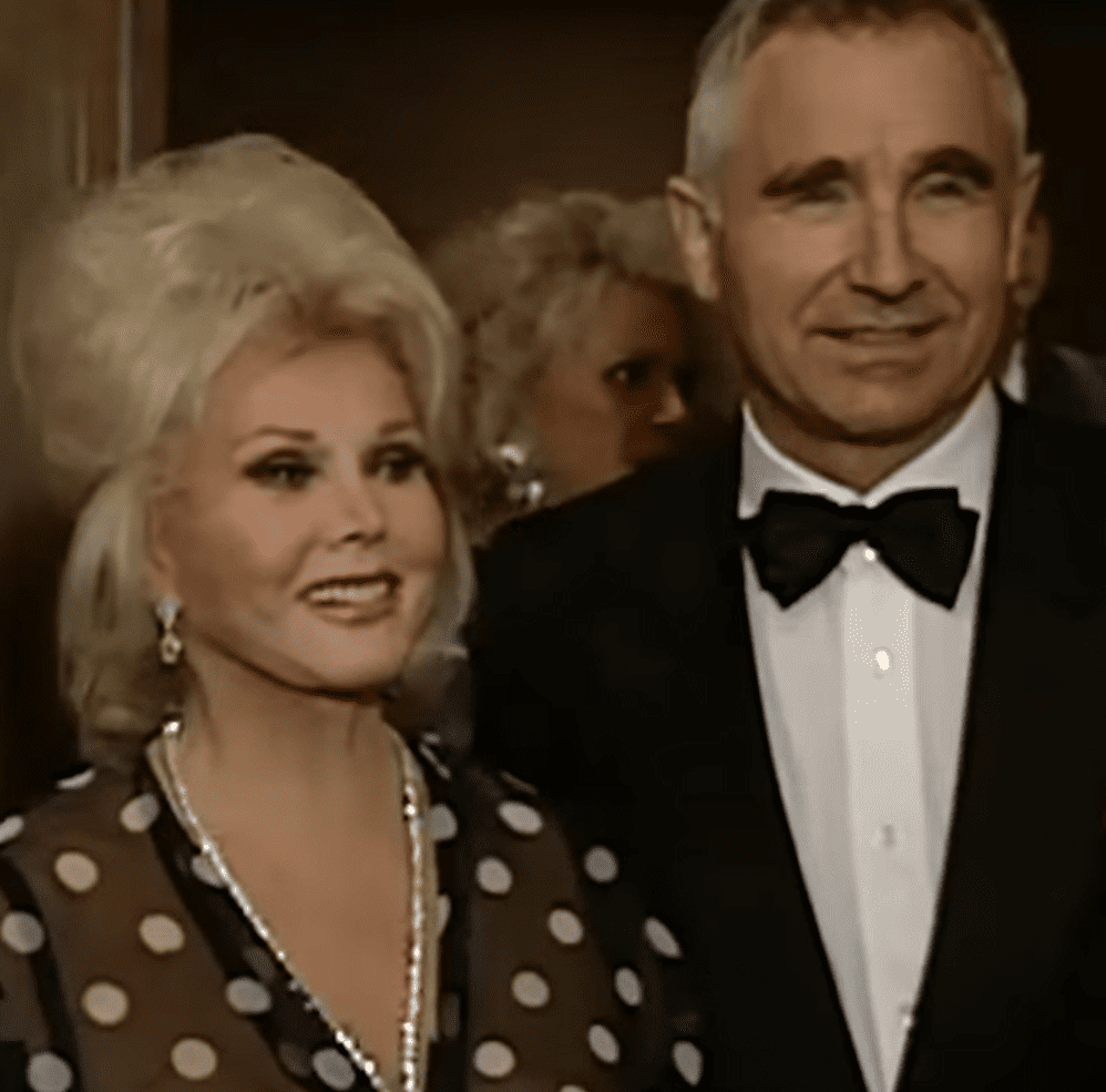 Hungarian actress Zsa Zsa Gabor and her husband Frédéric Prinz von Anhalt attend an event together. | Source: youtube.com/Entertainment Tonight