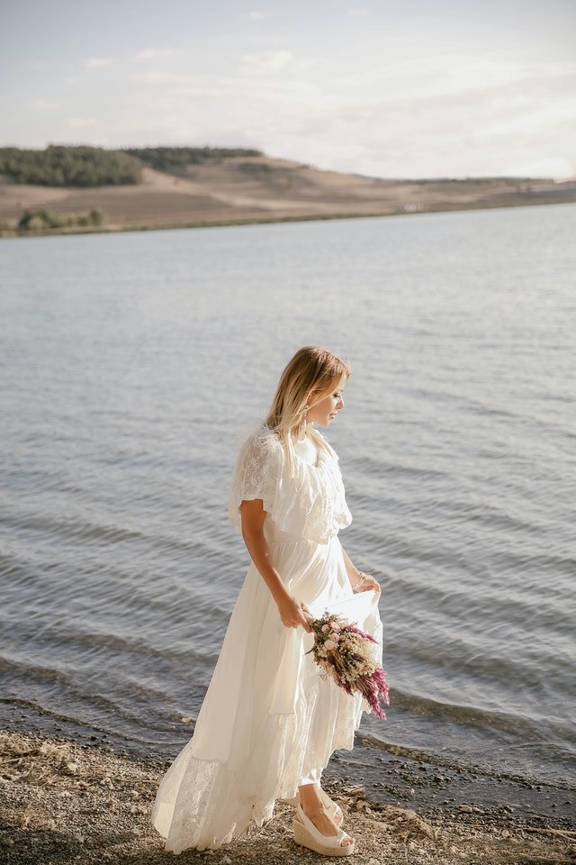 Une femme mariée au bord d'un cours d'eau | Photo : Pexels.