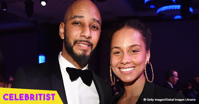 Swizz Beatz praises his wife's beauty with photo of her in a fringed black bodysuit & high heels