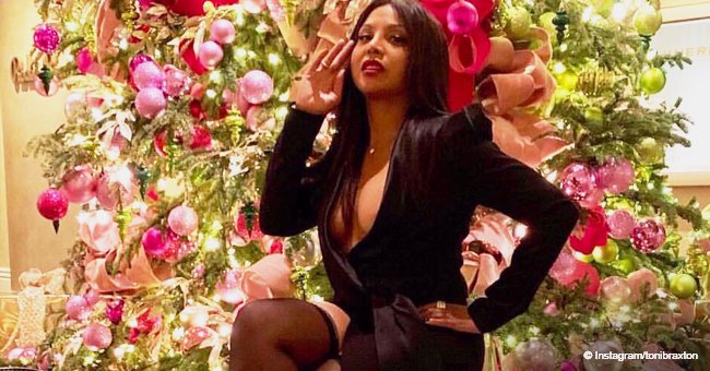 Toni Braxton gets praised for her youthful look in thigh-high stockings & plunging dress in photo