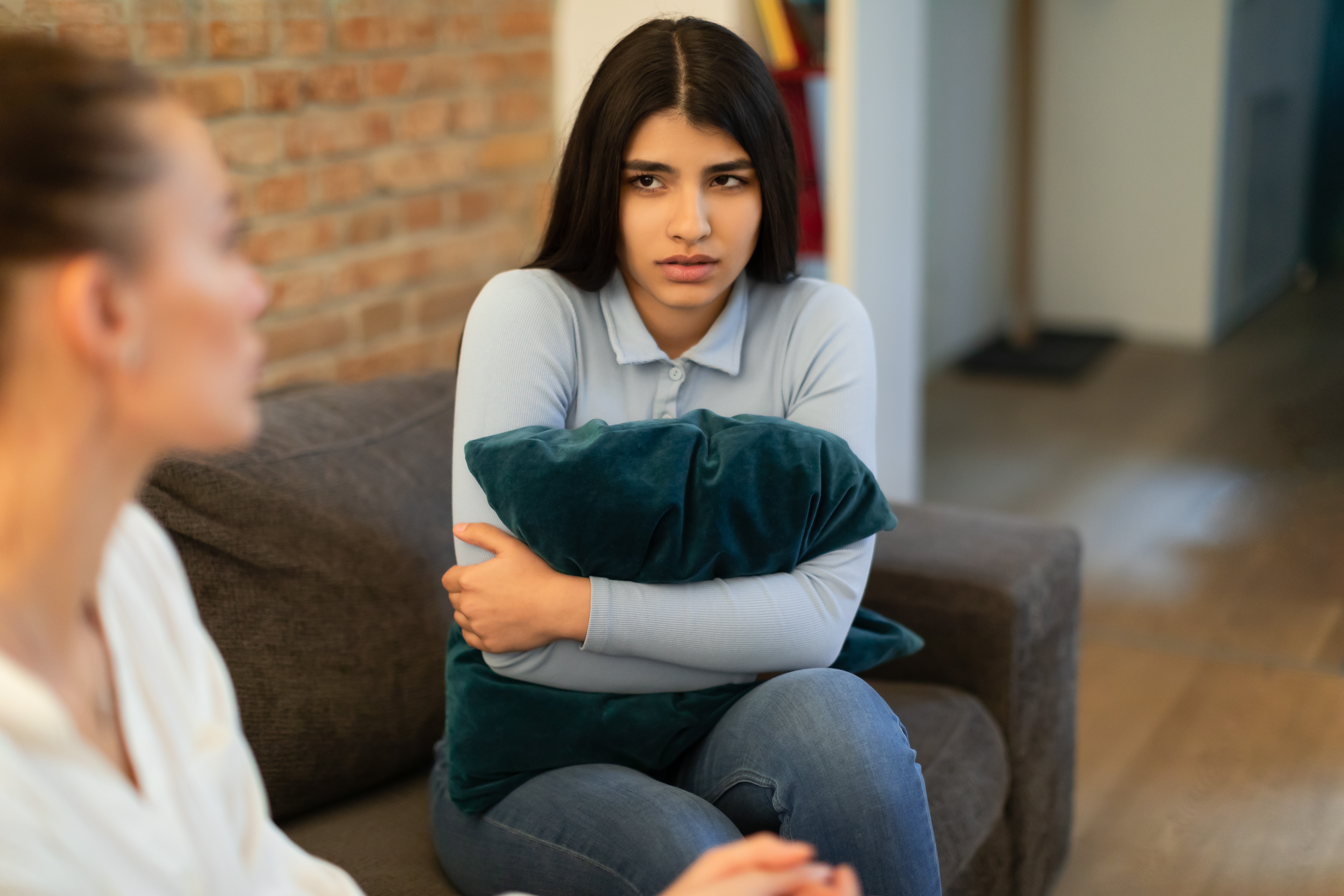 A woman has a serious conversation with a teenage girl | Source: Shutterstock