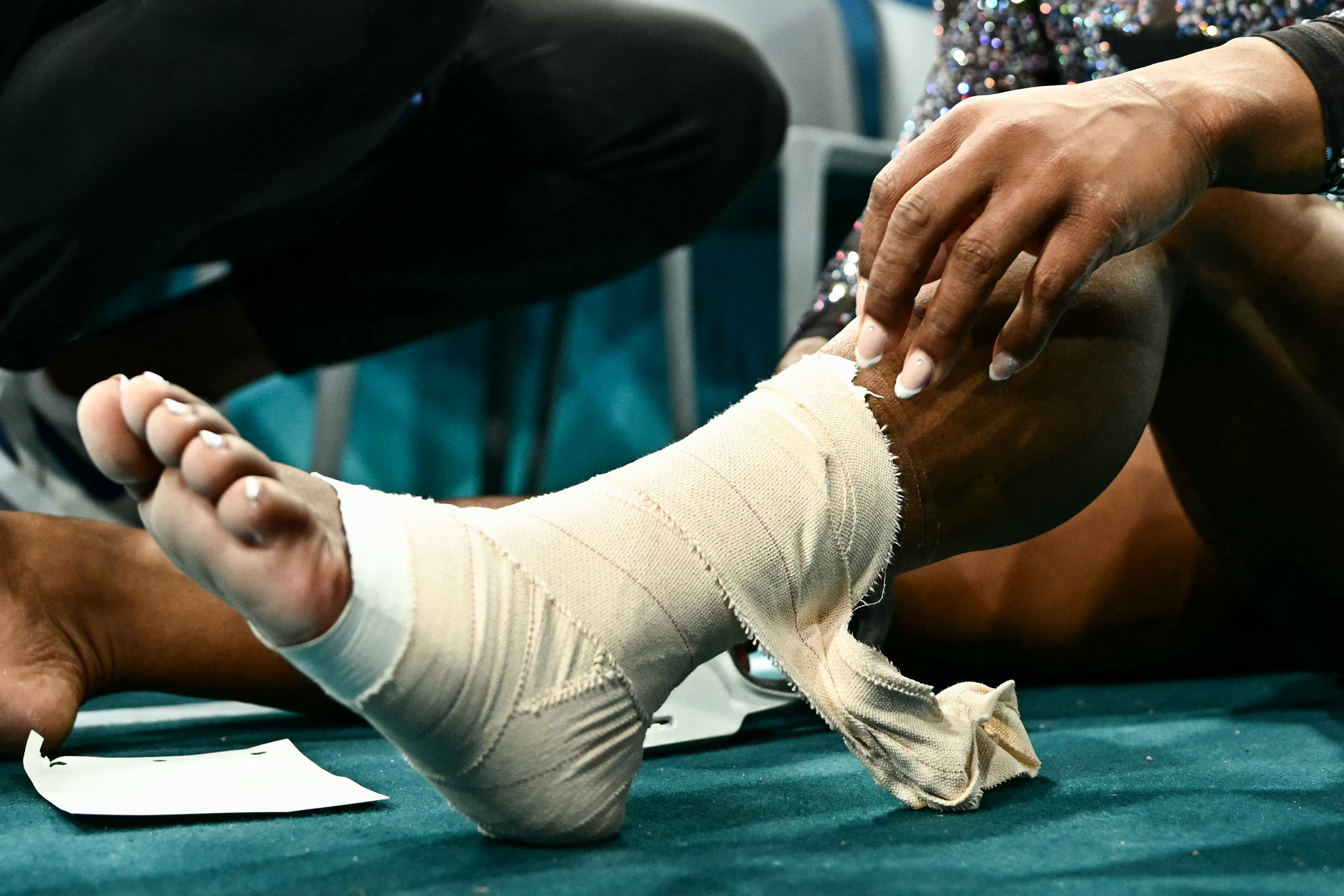 A close-up of Simone Biles' bandaged ankle and calf during the Artistic Gymnastics Women's Qualification in Paris, France on July 28, 2024 | Source: Getty Images