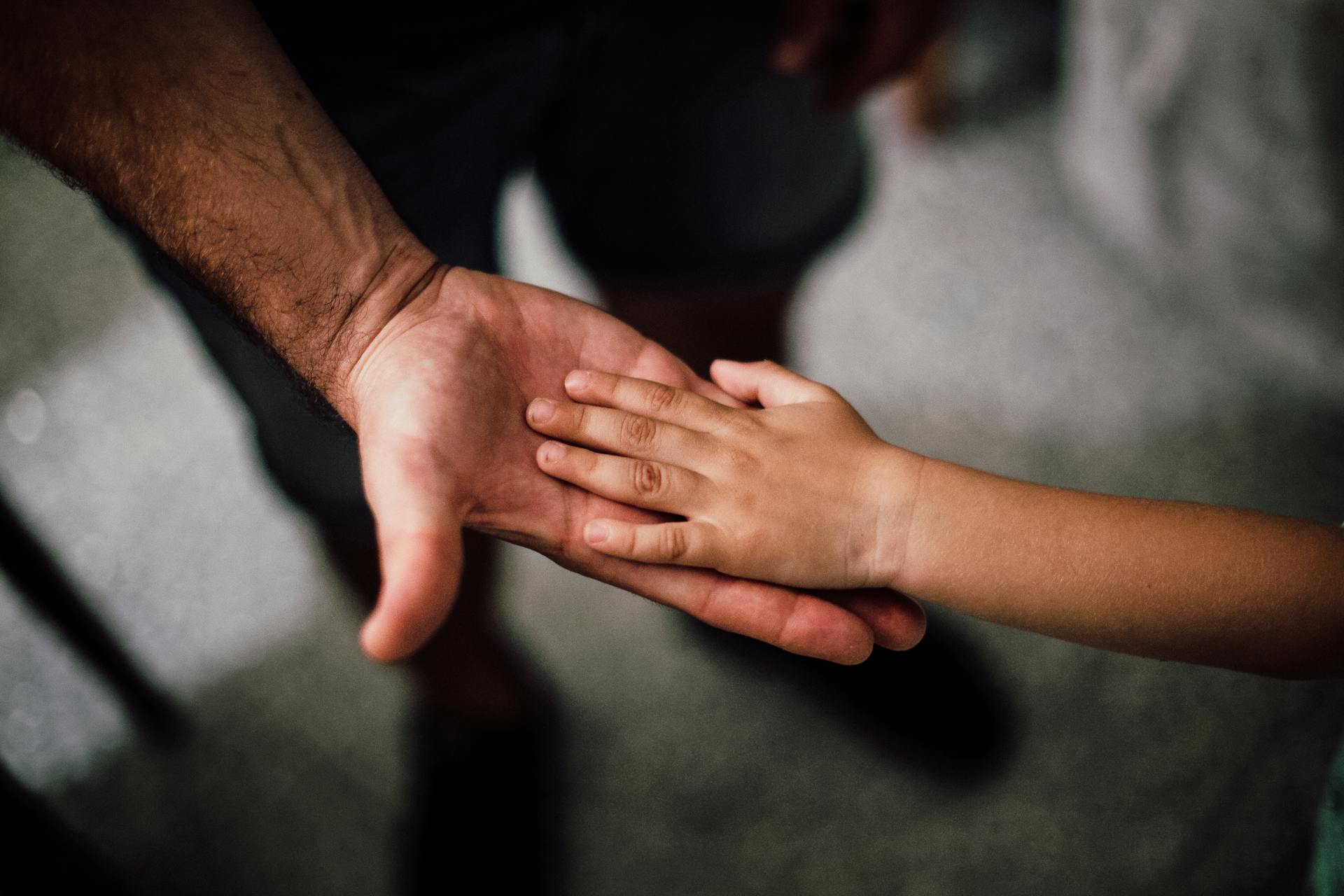 A man holding a child's hand | Source: Pexels