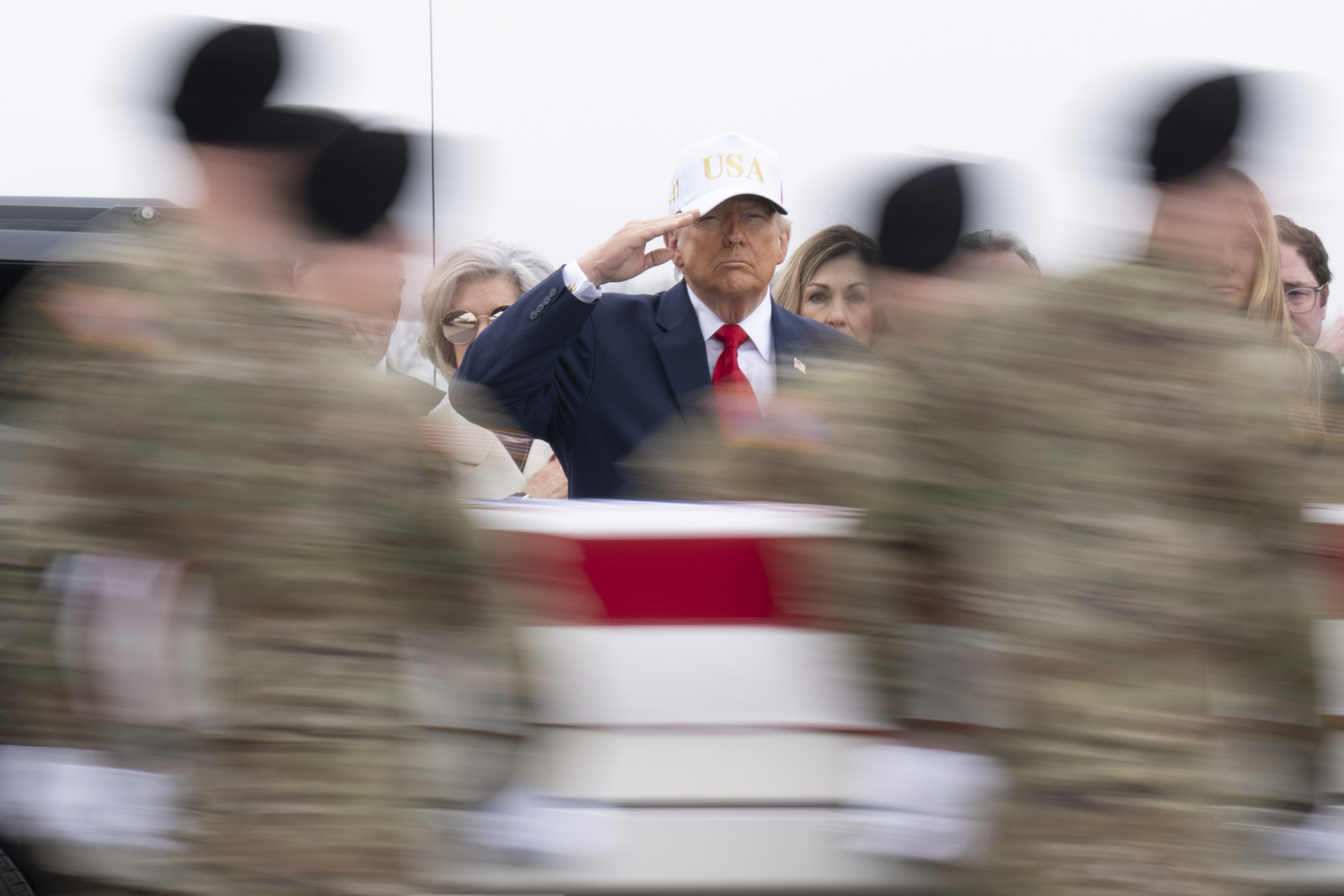 U.S. President Donald Trump salutes as a U.S. Army carry team moves a flag-draped transfer case containing the remains of Sgt. 1st Class Nicole M. Amor at Dover Air Force Base on March 7, 2026 in Dover, Delaware | Source: Getty Images