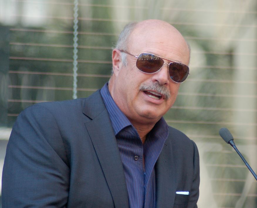 Dr. Phil McGraw at a ceremony for Steve Harvey who received a star on the Hollywood Walk of Fame on May 13, 2013 | Photo: Angela George/Wikimedia