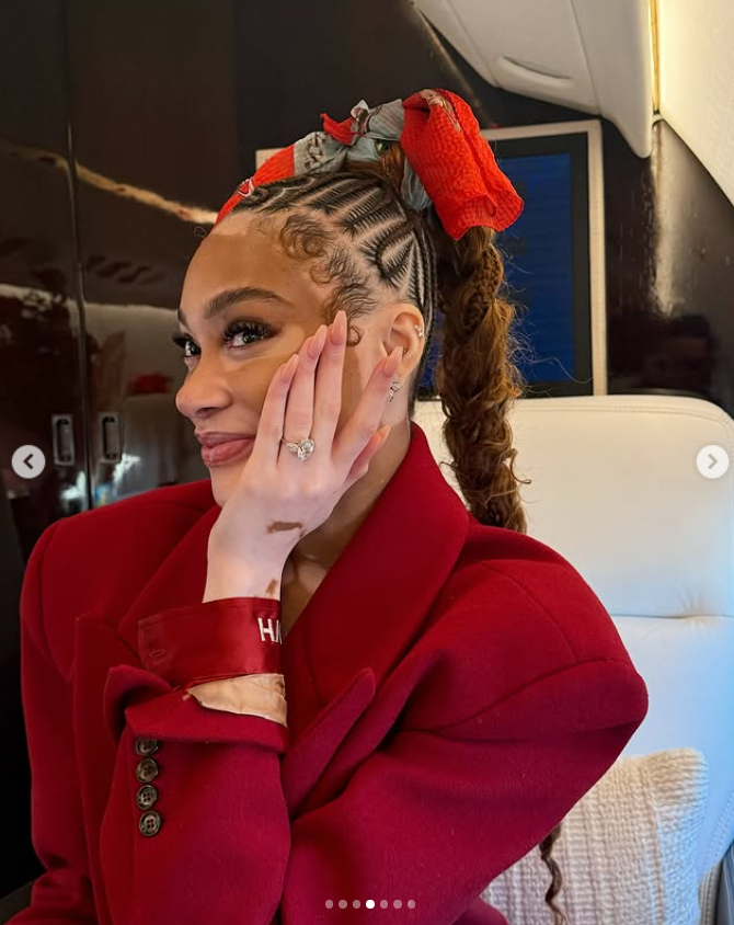 A close-up of Winnie Harlow smiling while resting her face on her hand, proudly showing off her engagement ring | Source: Instagram/winnieharlow