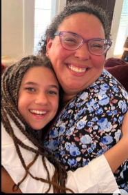 Alyxandra Beatris Brown posing for a picture with a family member on June 26, 2023 | Source: Instagram/magicallydeliciouz