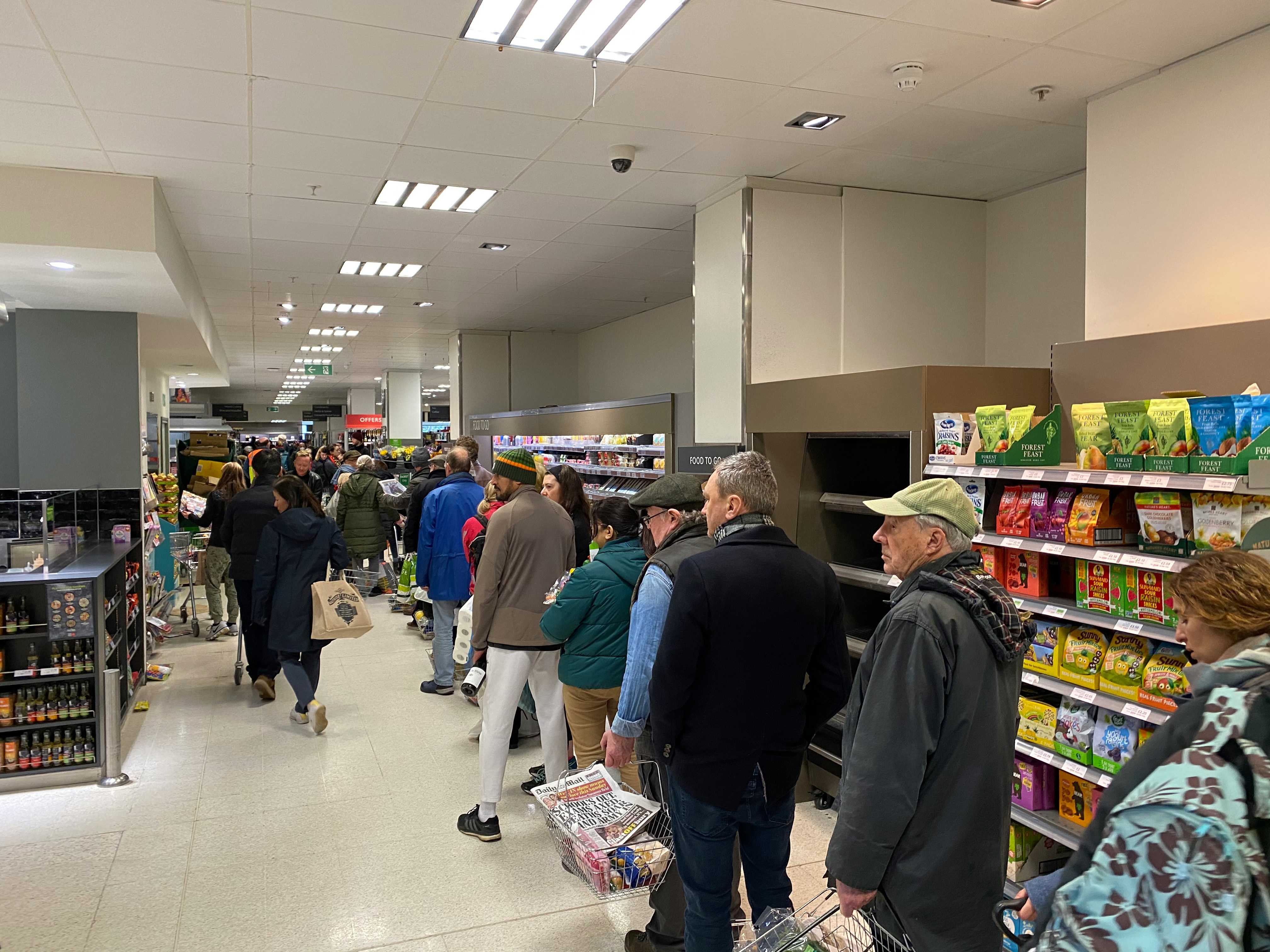People standing in a queue at a store | Source: Unsplash