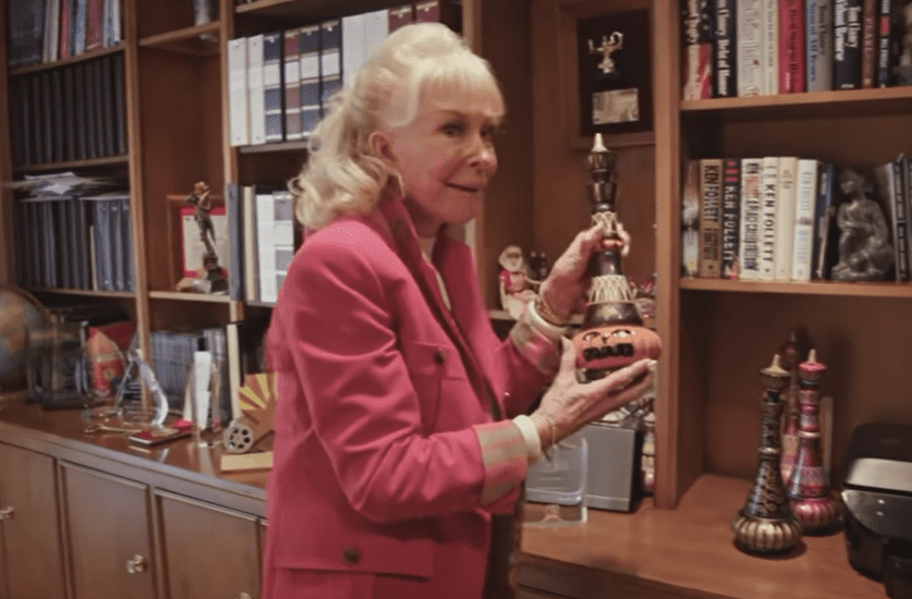 A picture of legendary entertainer, Barbara Eden showing off her collection of genie bottles | Photo: Youtube/PEOPLE