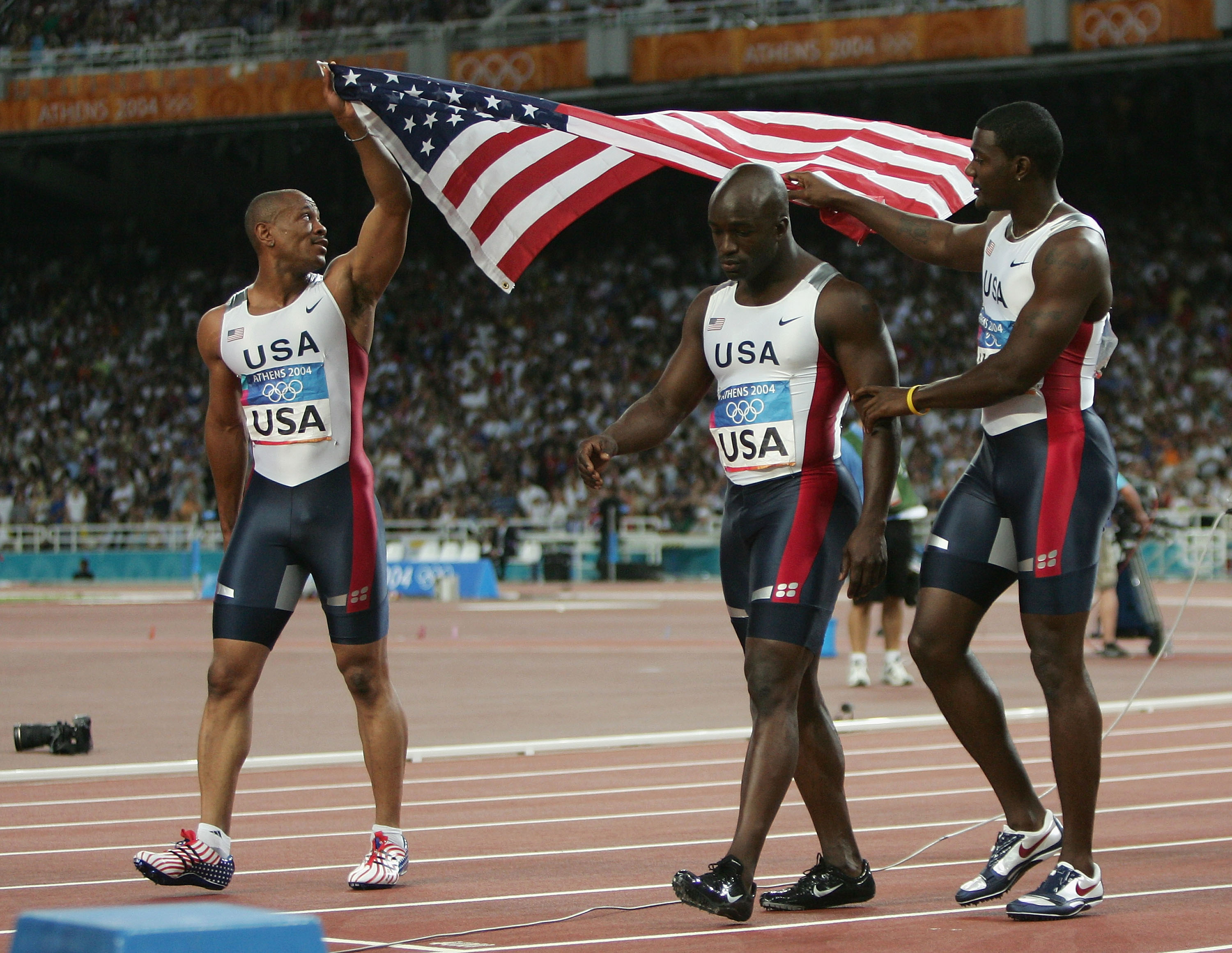 Maurice Greene, Coby Miller, and Shawn Crawford of Team United States after competing in the men's 4x100-meter Relay Final during the Athens 2004 Summer Olympic Games on August 28, in Greece. | Source: Getty Images