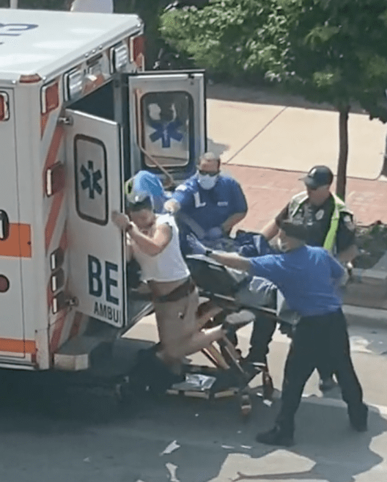 A viral video captured a man pushing medical staff off of him as he gets out of the ambulance | Photo: TikTok/meredithscharinge74 