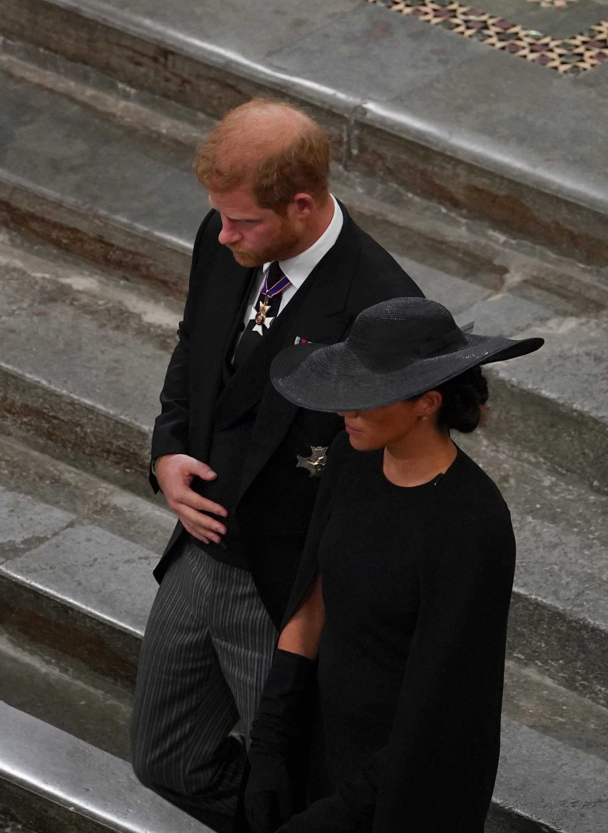 Prince Harry and Meghan Markle follow the bearer party with the coffin of Queen Elizabeth II as it leaves Westminster Abbey for Wellington Arch on September 19, 2022 in London, England | Source: Getty Images