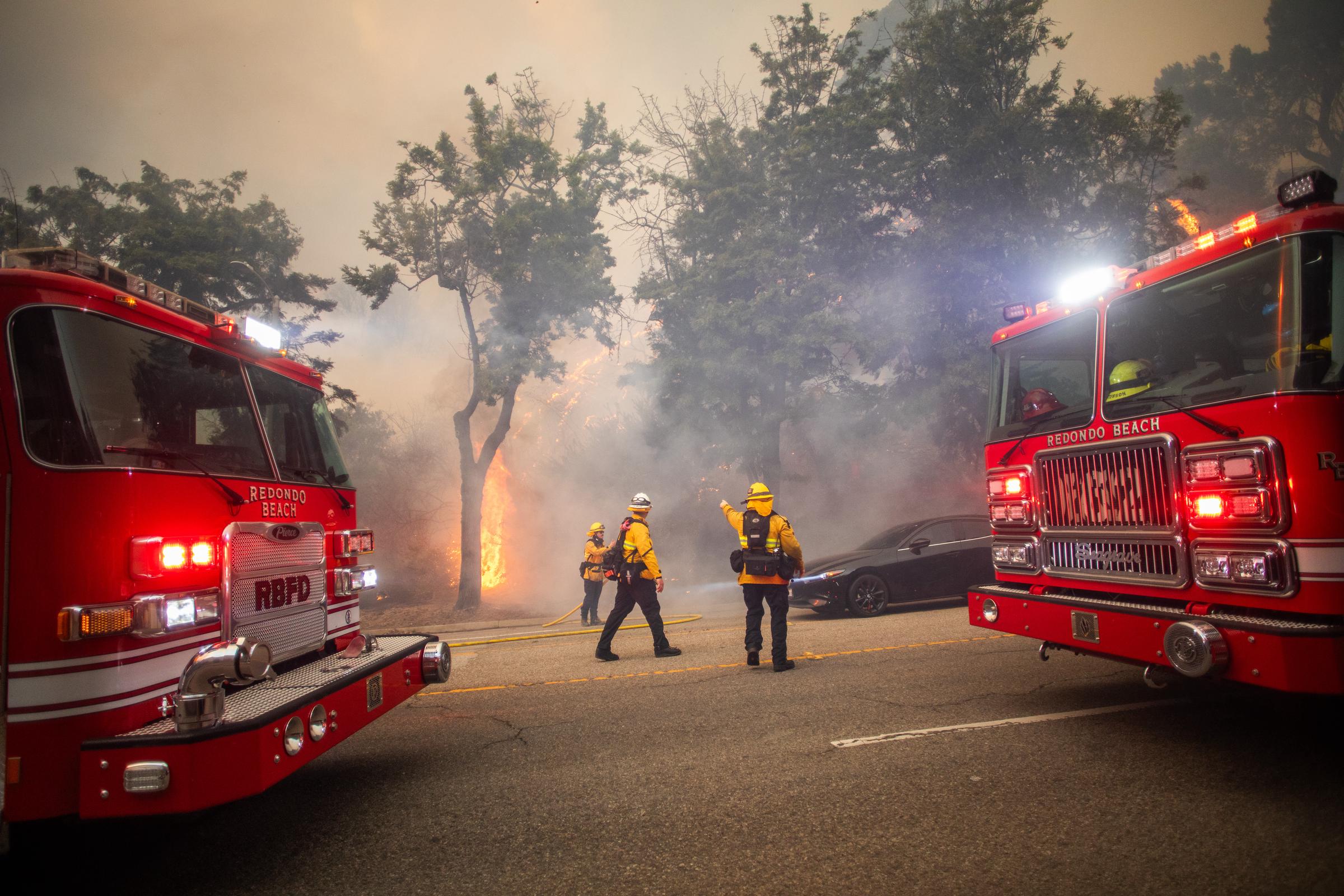 Firefighters control flames from the Palisades Fire on Sunset Boulevard during a strong windstorm on January 7, 2025 | Source: Getty Images