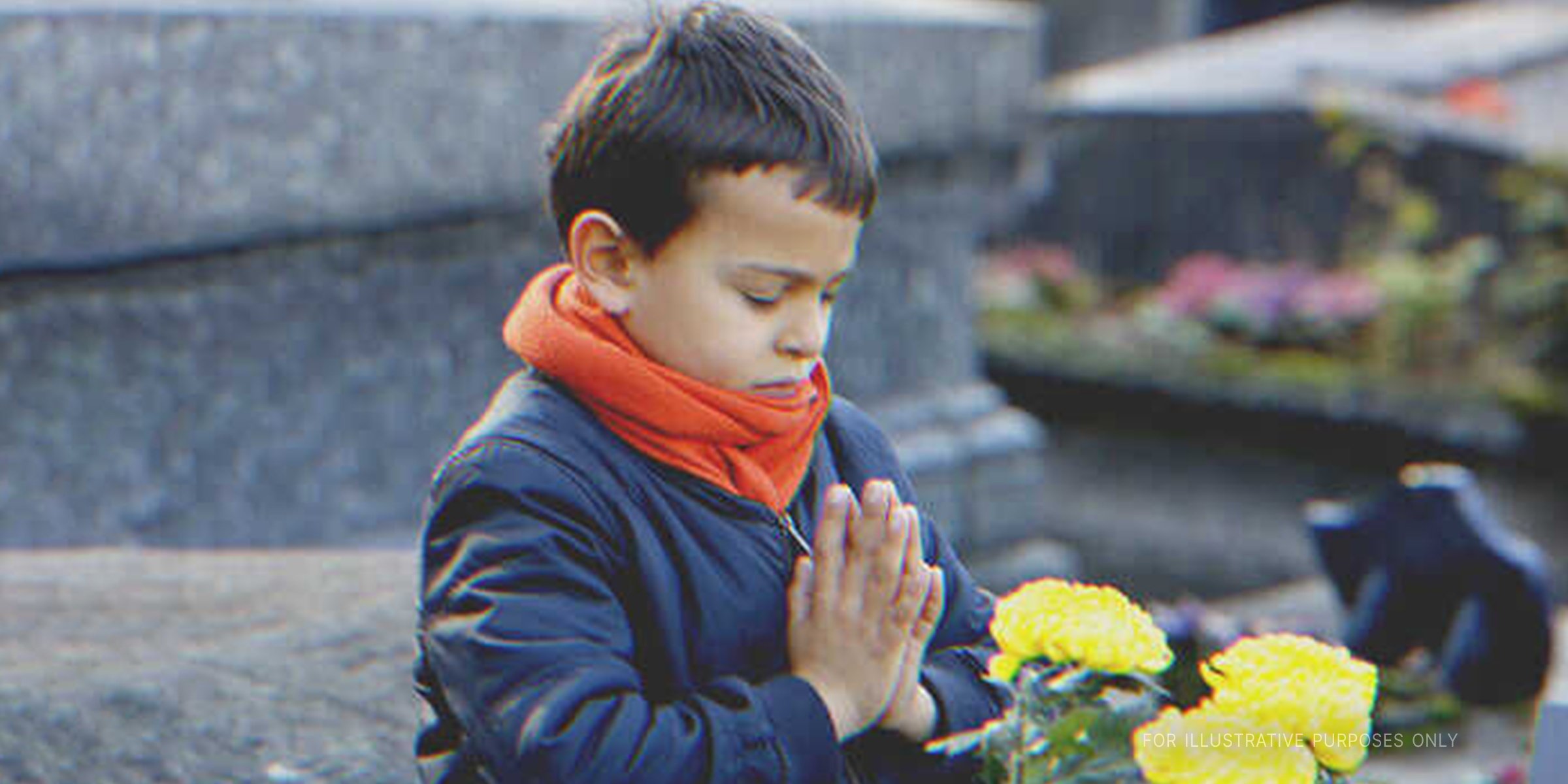 Little Boy Praying In Front Of His Mother's Grave. | Source: Getty Images