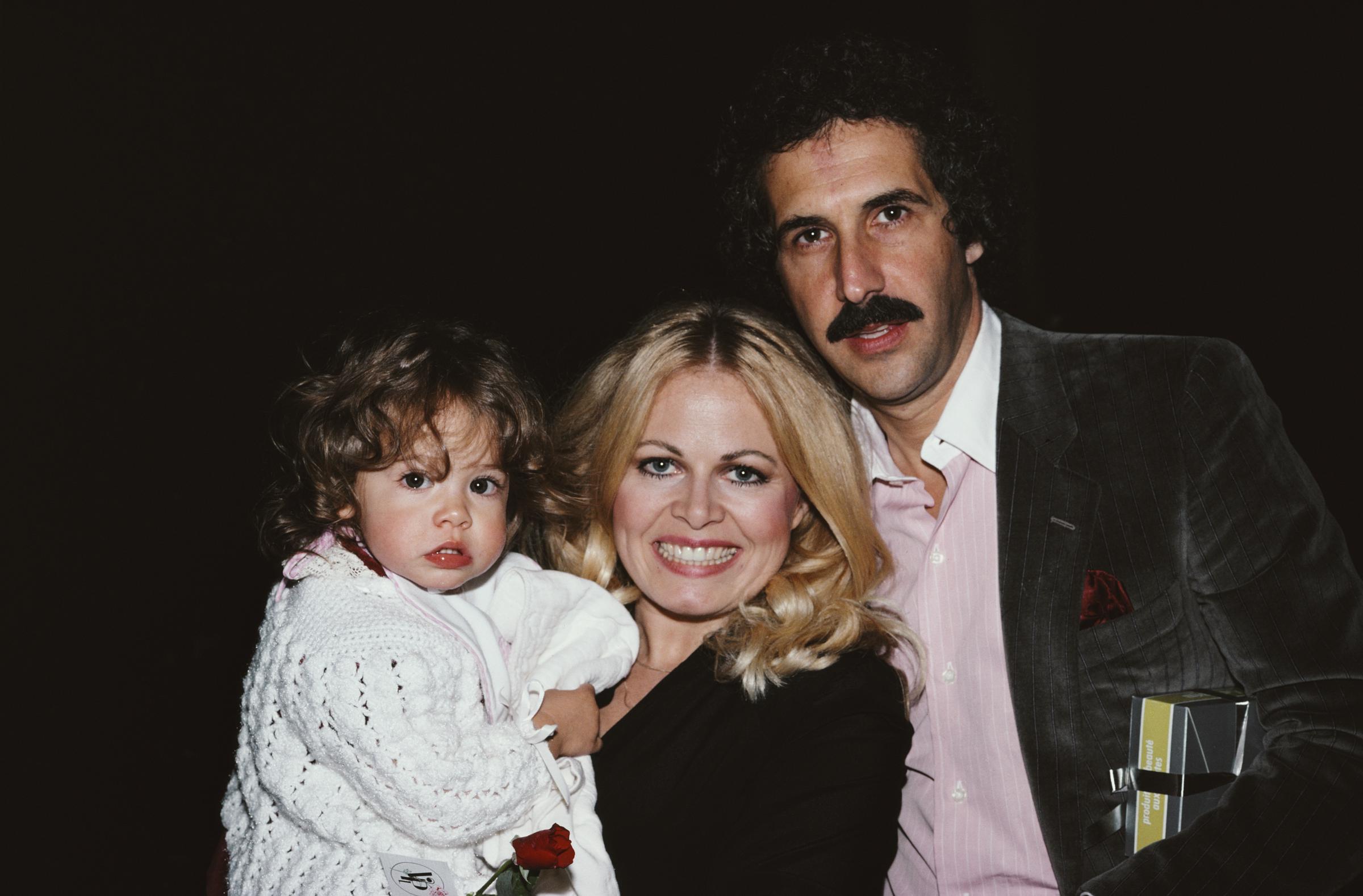 The actress, William C. Rader, and their daughter Samantha in December 1980 | Source: Getty Images