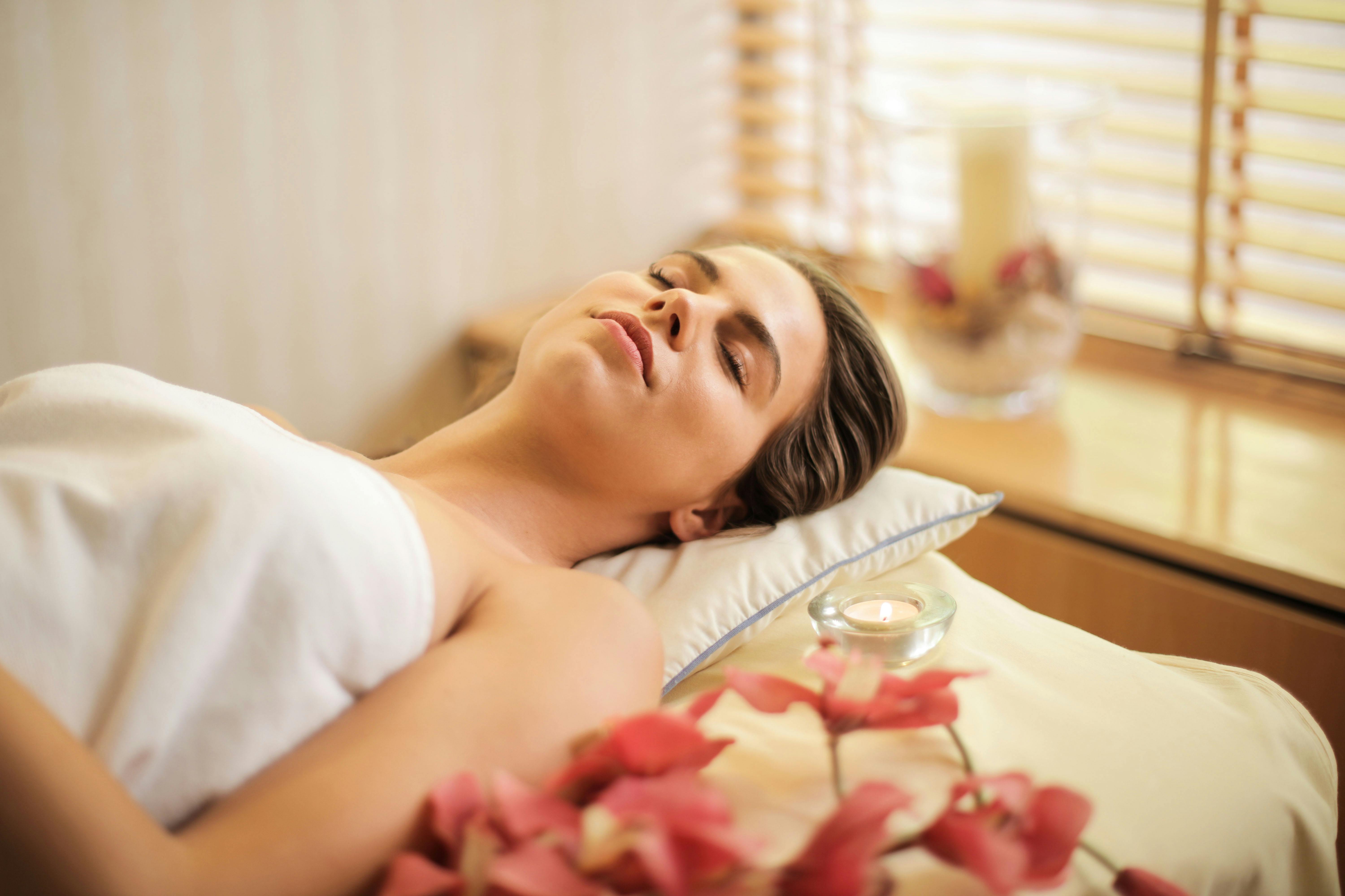 A woman with her eyes closed while enjoying a spa treatment | Source: Pexels