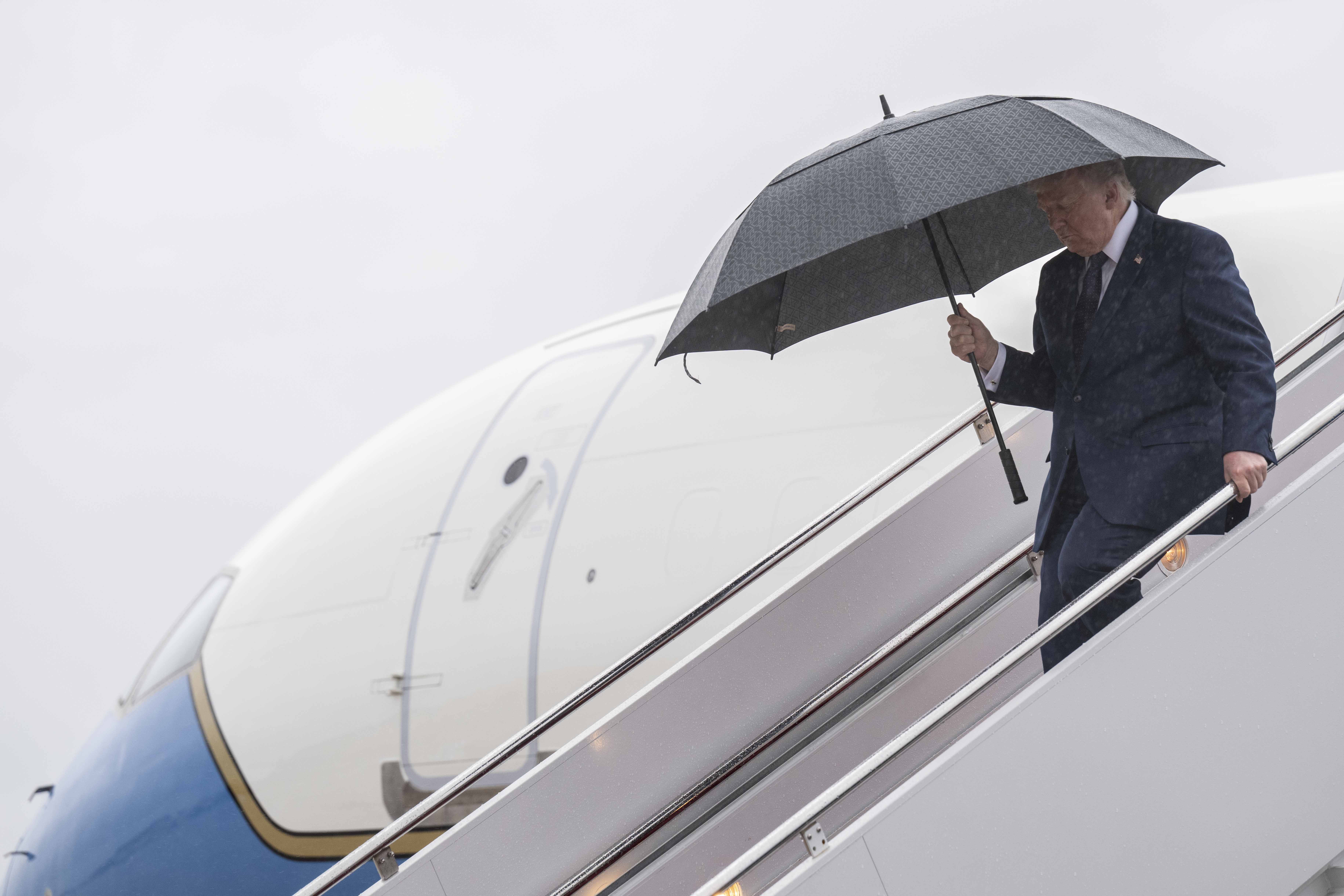 Donald Trump holds an umbrella after landing on May 22, 2026, in Joint Base Andrews, Maryland | Source: Getty Images