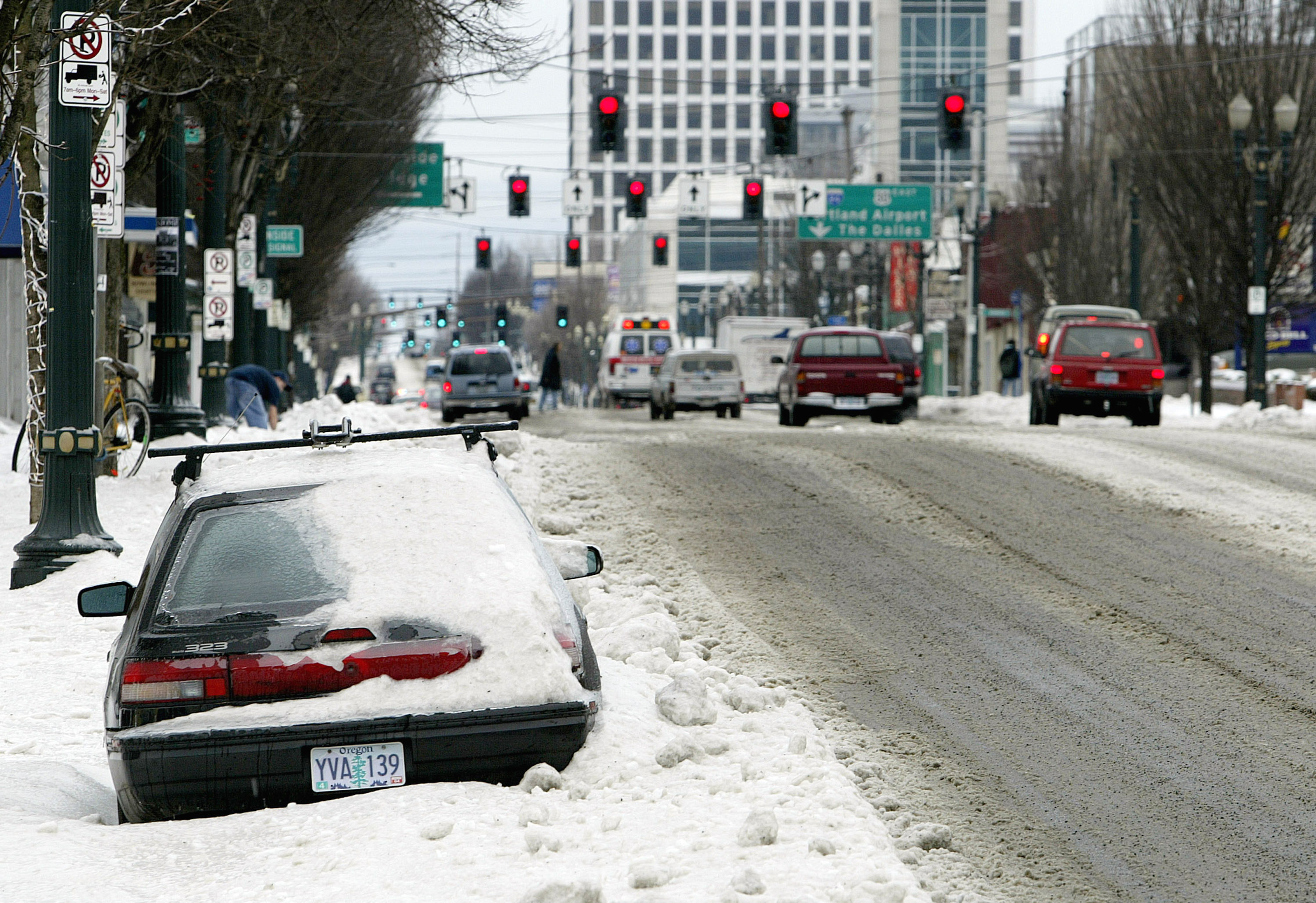 A snow-covered car by the roadside | Source: Getty Images