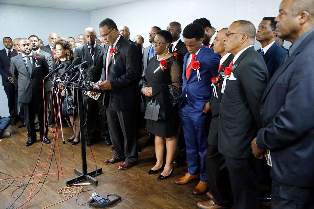 Church members stood with the family of Botham Shem Jean at a press conference after the funeral service at Greenville Avenue Church of Christ | Photo: Getty Images