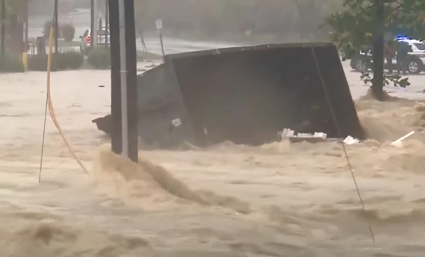 A dumpster floating in the water, as seen in a video dated October 3, 2024 | Source: YouTube/Global News