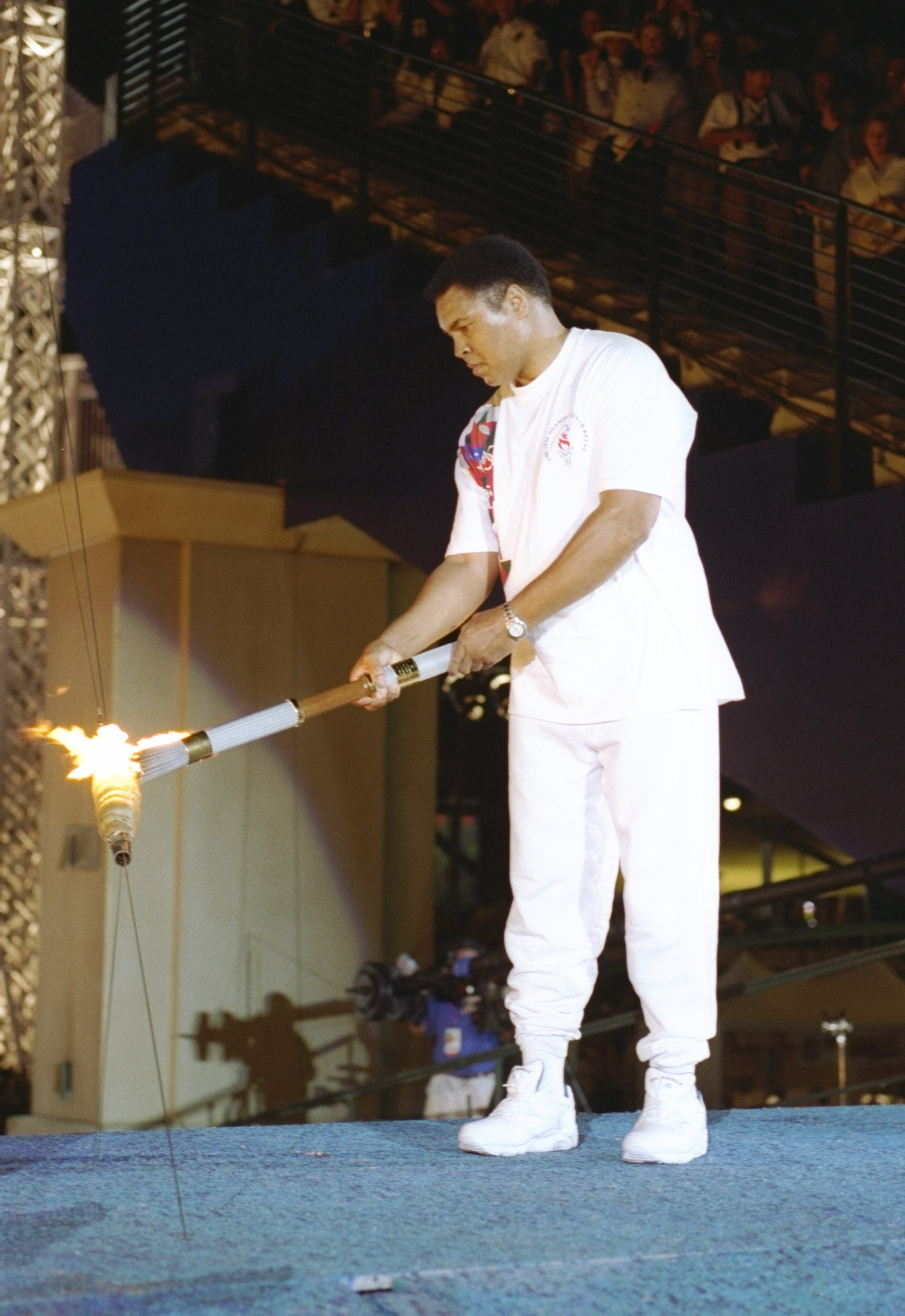 Muhammad Ali holds the torch before lighting the Olympic Flame on July 19, 1996, in Atlanta, Georgia. | Source: Getty Images