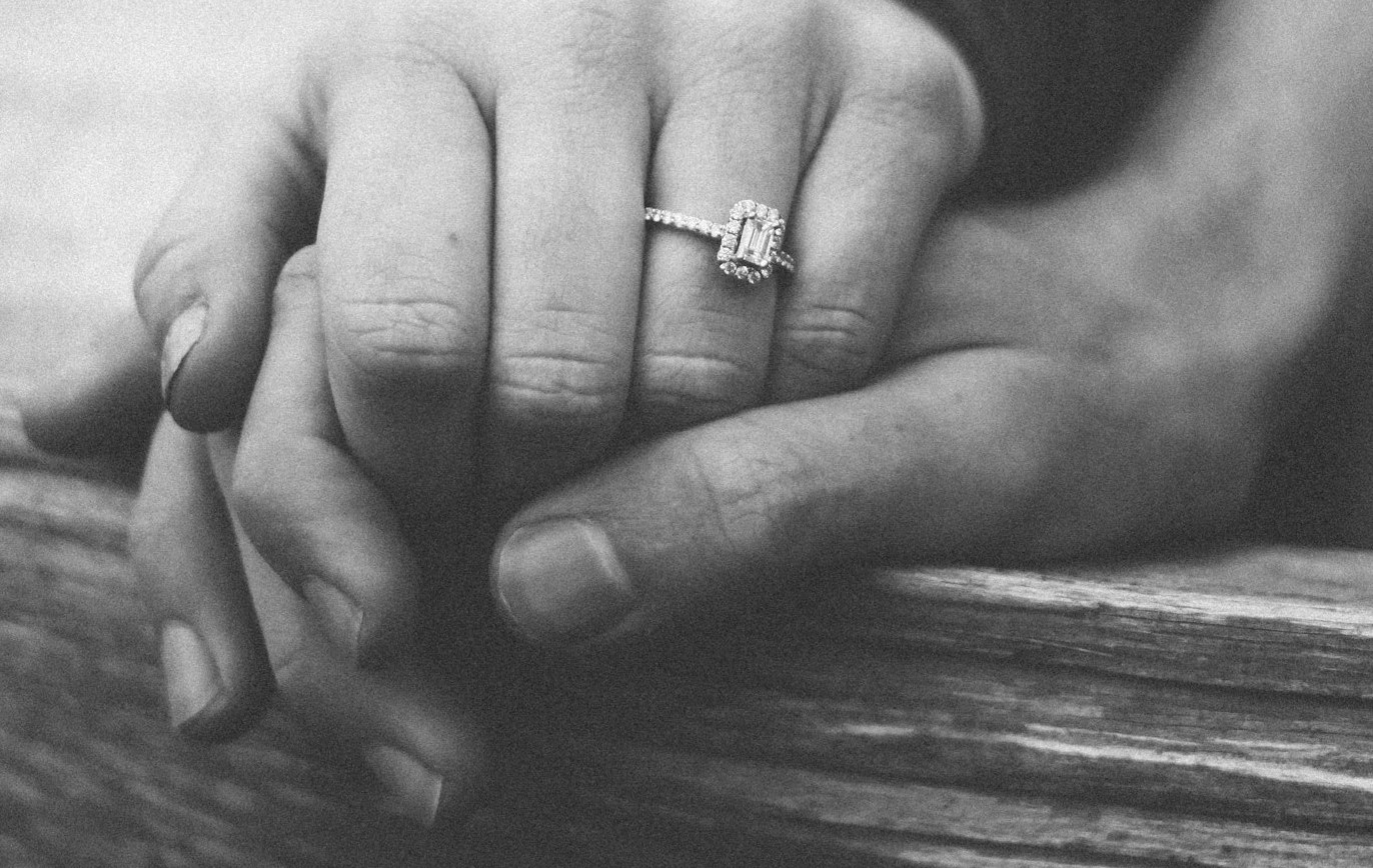 Grayscale shot of a couple holding hands | Source: Unsplash