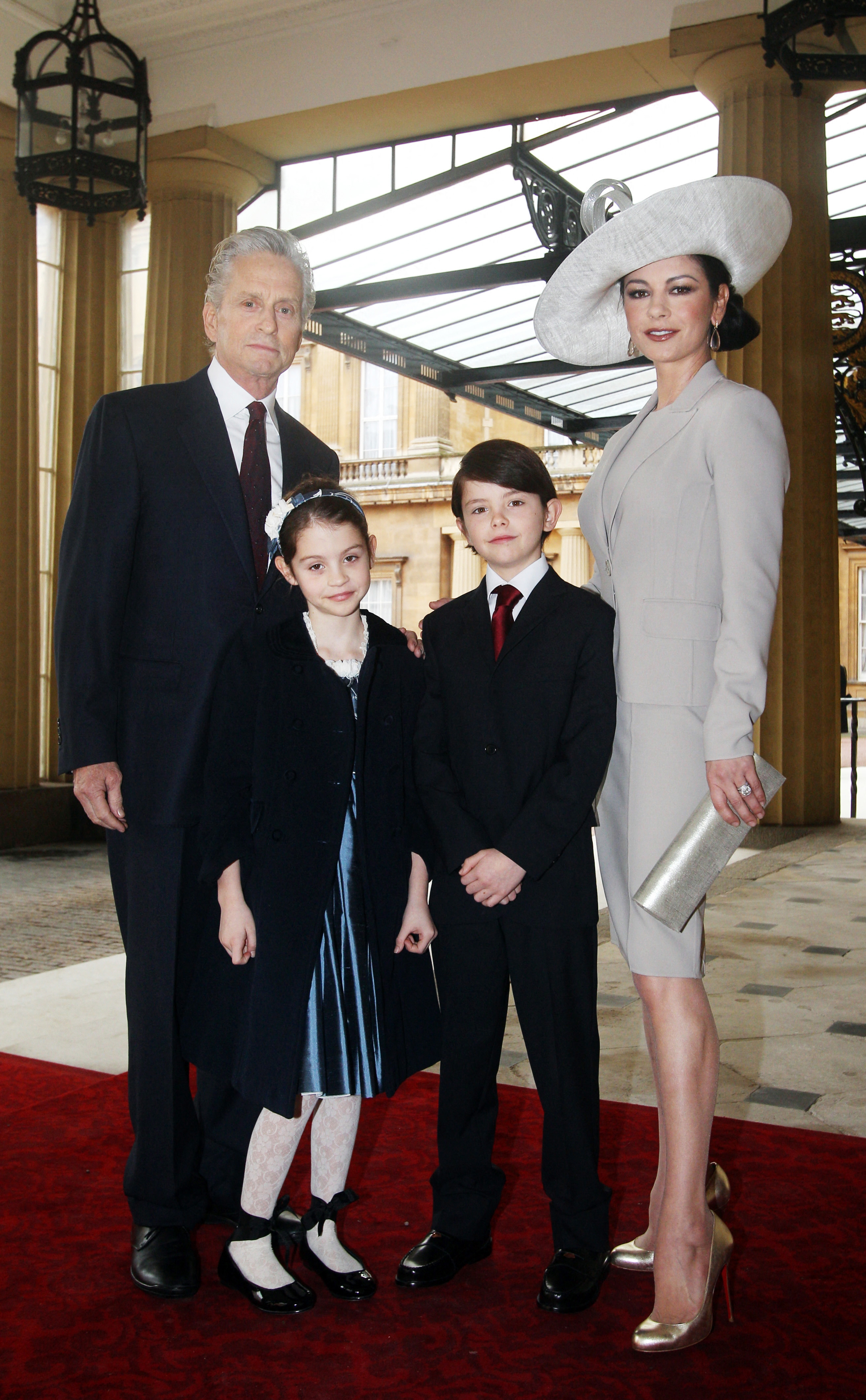 Catherine Zeta-Jones, Michael Douglas, and their children Dylan and Carys at Buckingham Palace in Central London on February 24, 2011 | Source: Getty Images