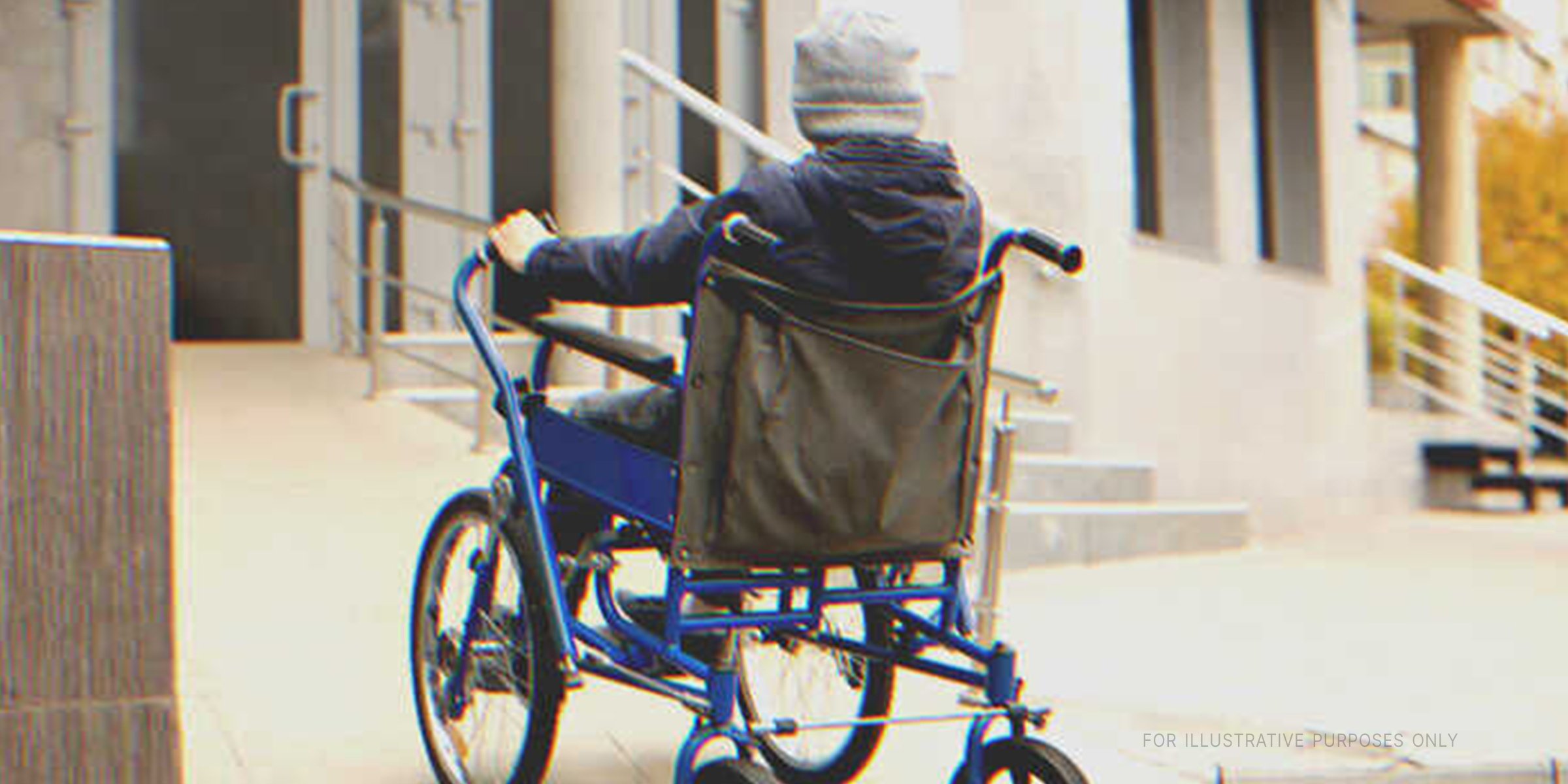 Boy in wheelchair outside a building | Source: Shutterstock