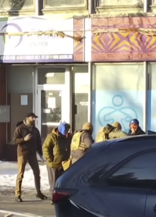 Alex Pretti seen holding a mobile phone while filming from a video posted on January 25, 2026 |  Source: YouTube/@fox9