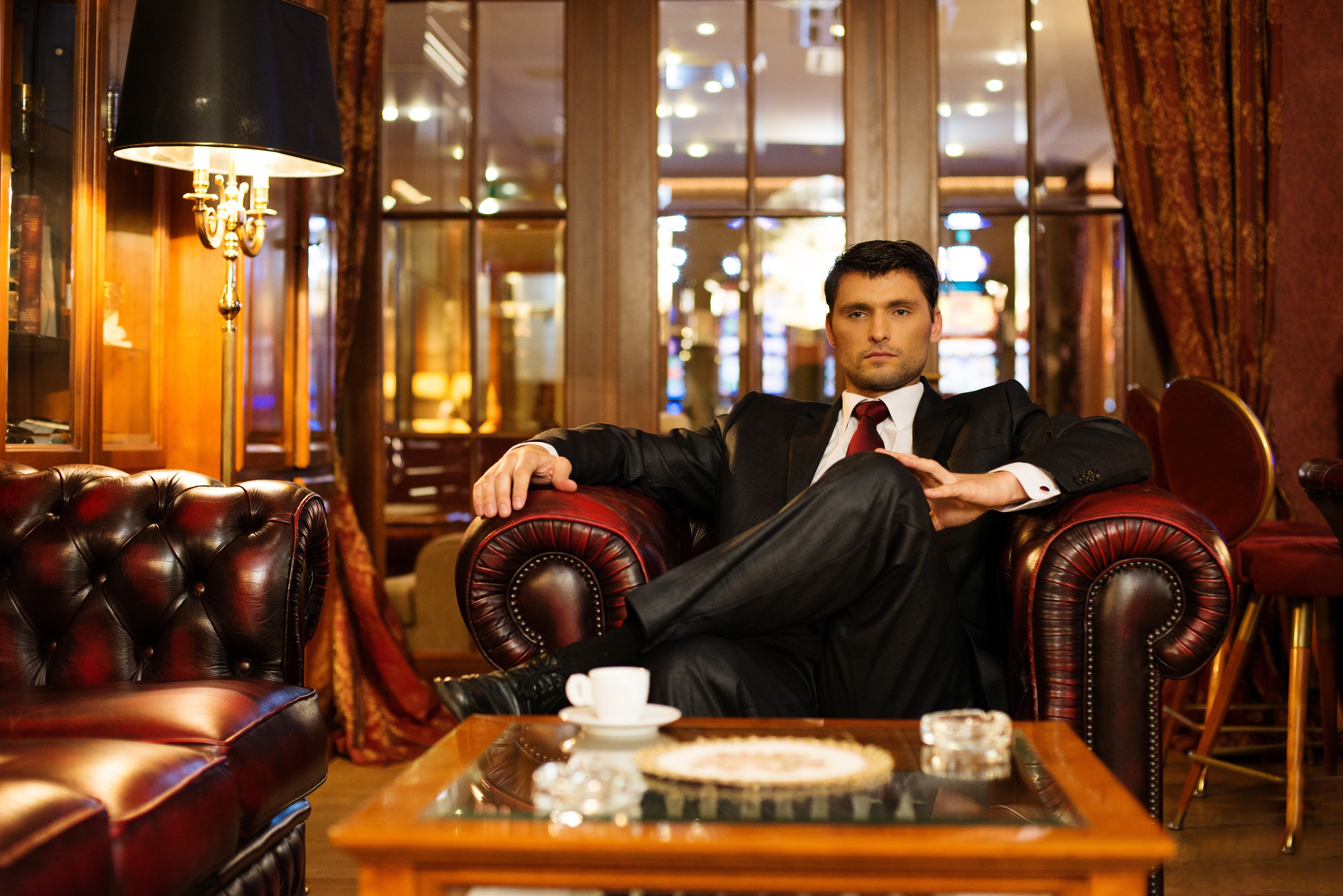 Confident handsome brunette sitting in luxury interior. | Source: Shutterstock