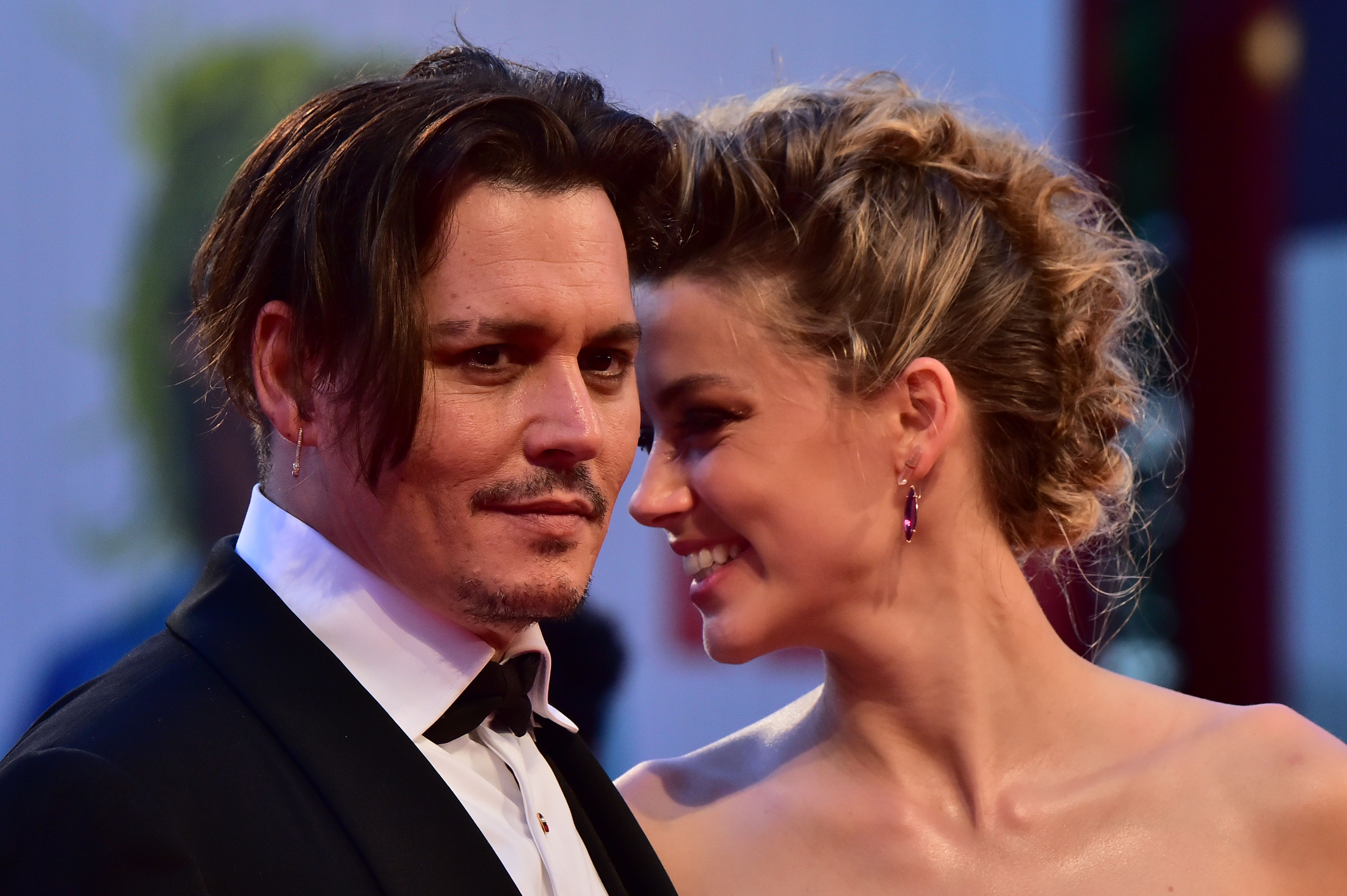  Amber Heard arrives with Johnny Depp for the screening of the movie "The Danish Girl" presented in competition at the 72nd Venice International Film Festival on September 5, 2015 at Venice Lido. | Source: Getty Images