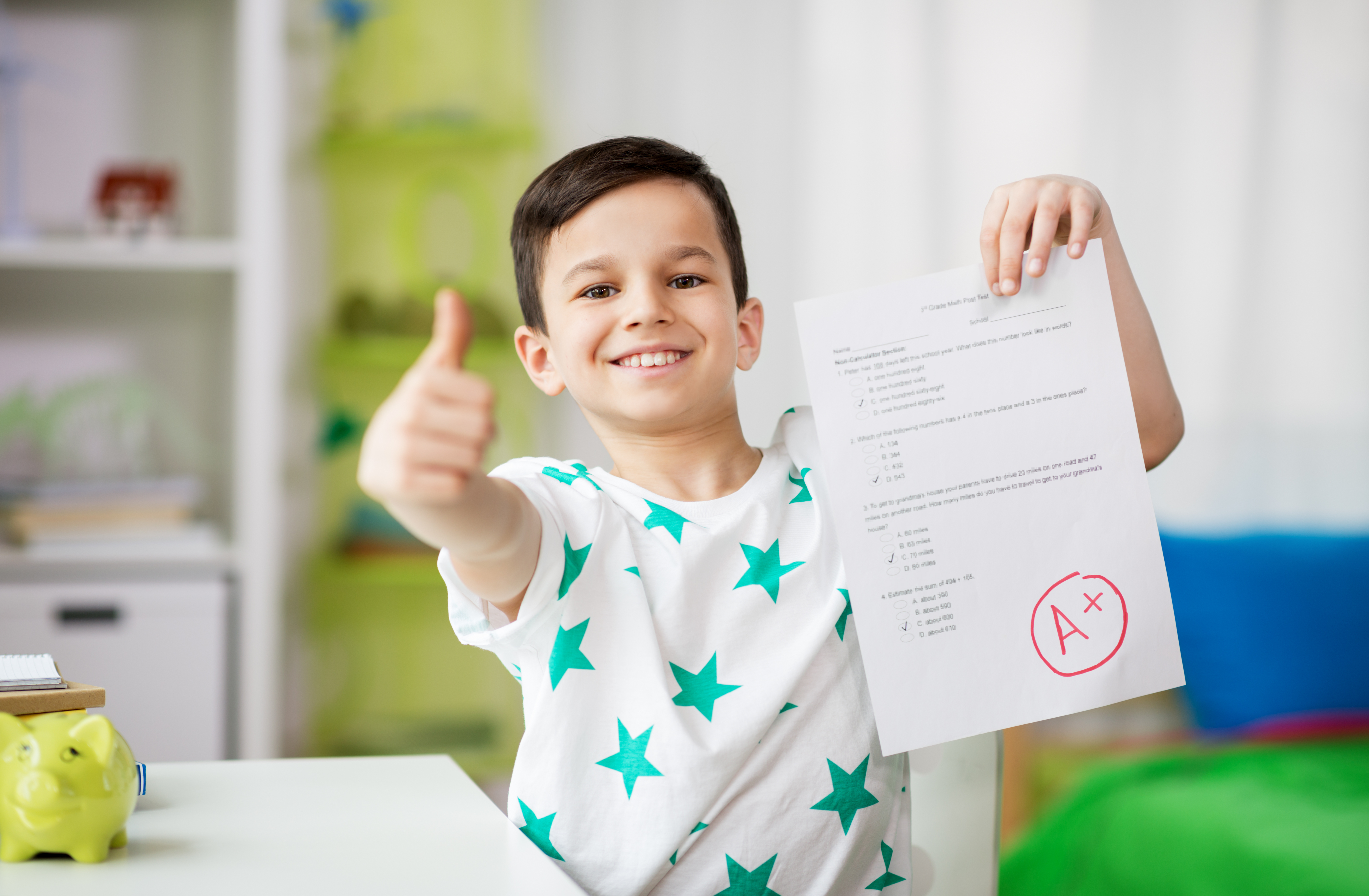 A child showing off their A+ grade on a school paper | Source: Shutterstock