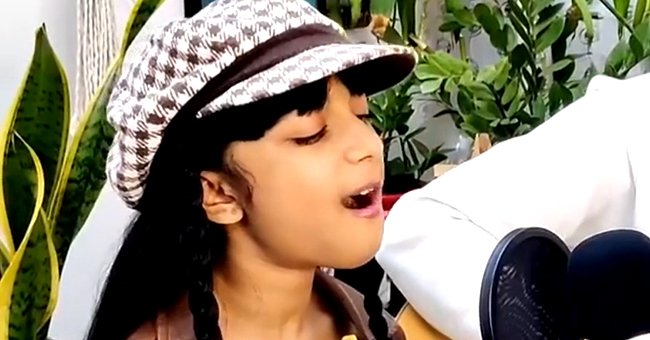9-year-old Megan Rakesh singing into a microphone. | Source: instagram.com/megandthemiracles