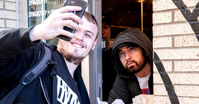 Eminem posing for a selfie with a fan at Mom's Spaghetti at the opening night of the restaurant in Detroit, Michigan | Photo: Scott Legato/Getty Images